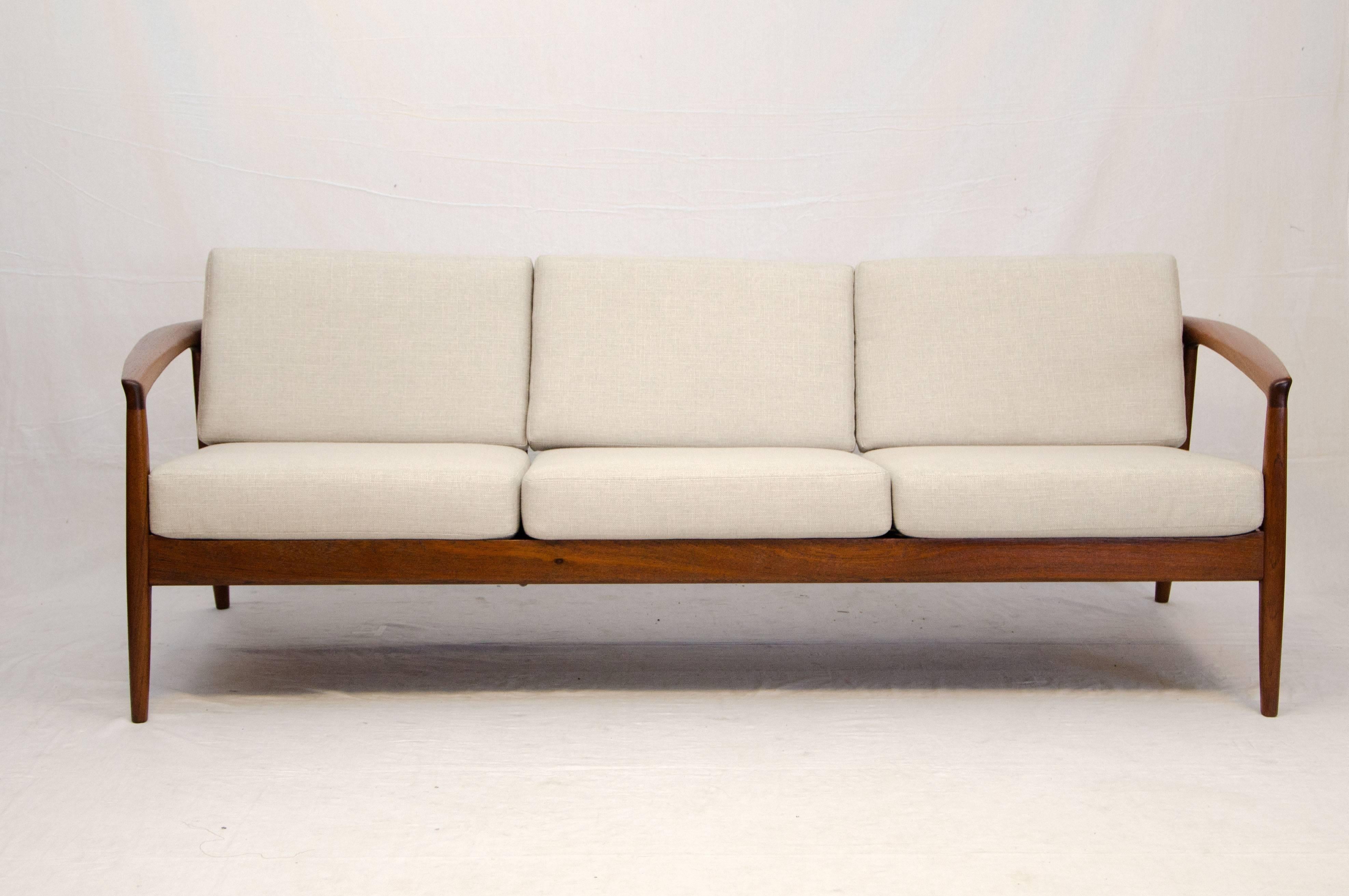 Very nice walnut sofa frame with a flowing rounded design. The strapping under the seat cushions has been replaced and the upholstery fabric and cushion interiors are new as well. The 4