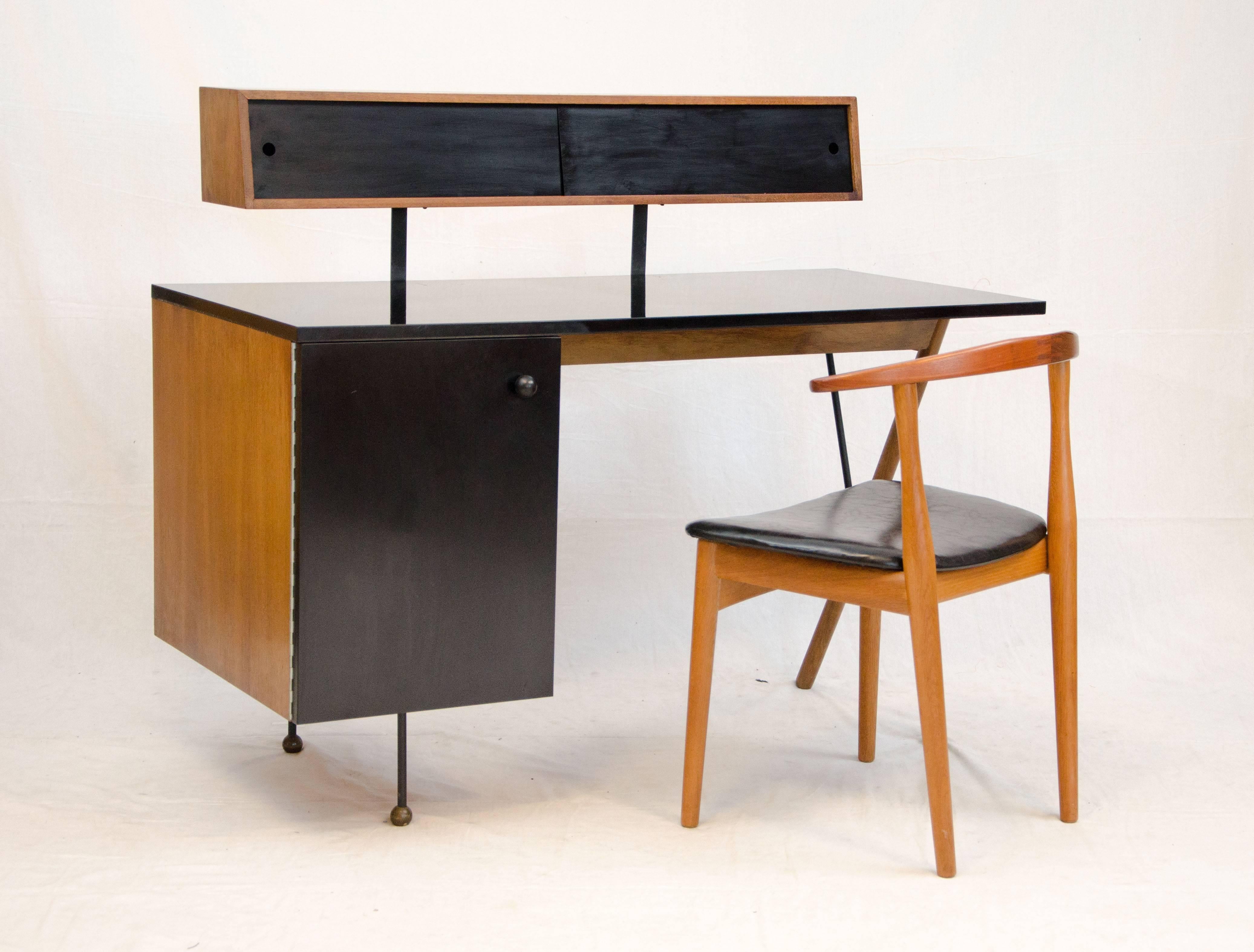 Rare and beautiful California modern desk designed by Greta Grossman and manufactured by Glenn of California. This example is all original and has a complete cabinet interior with both drawers and a pull out shelf. This desk is also the early
