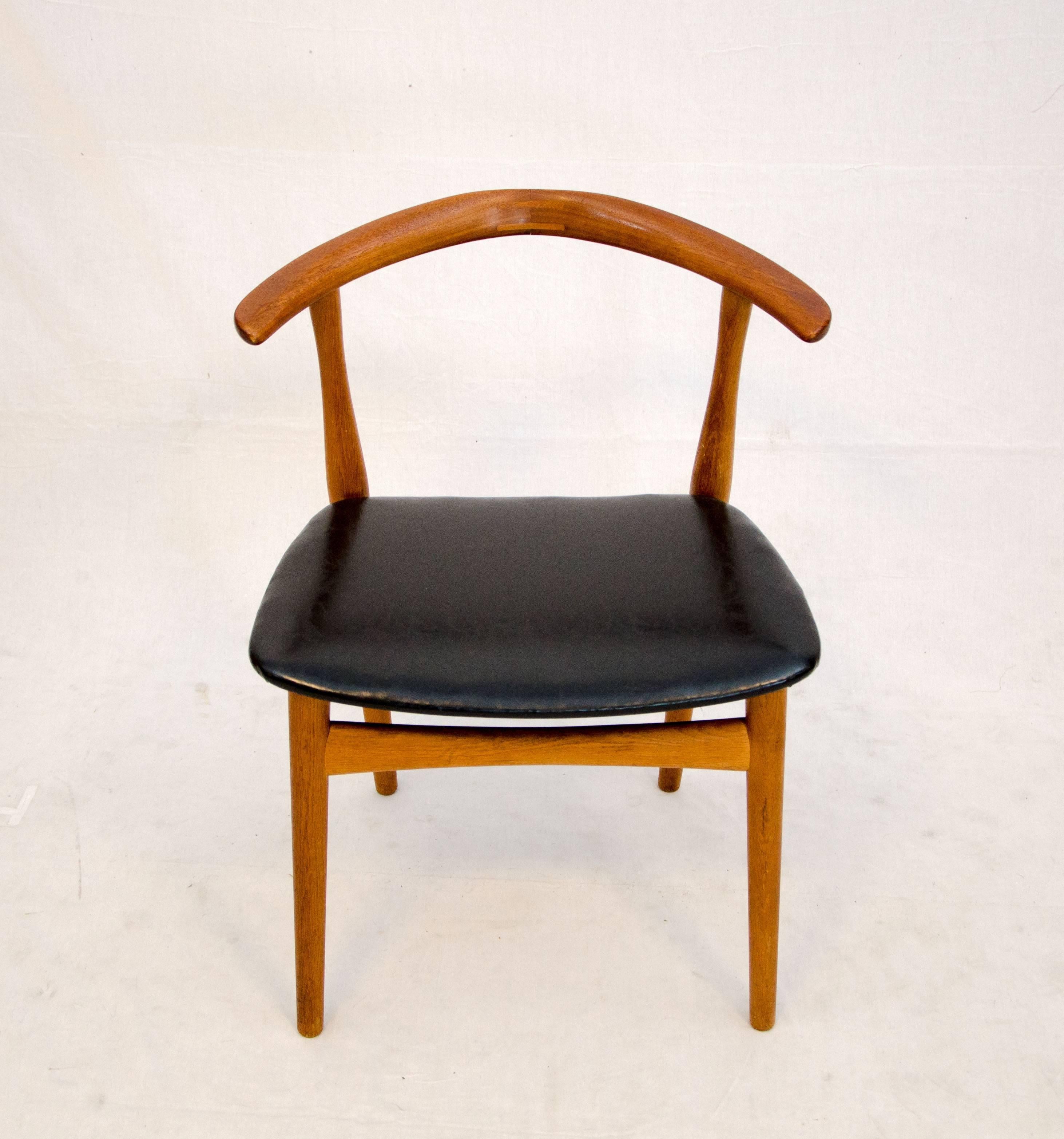 Unusual Danish teak chair designed by Architekt Kjærnulf and manufactured by Bruno Hansen The center of the contoured back is accented by inlaid joinery. The chair has designer and manufacturer marks as pictured. It would be an excellent desk or
