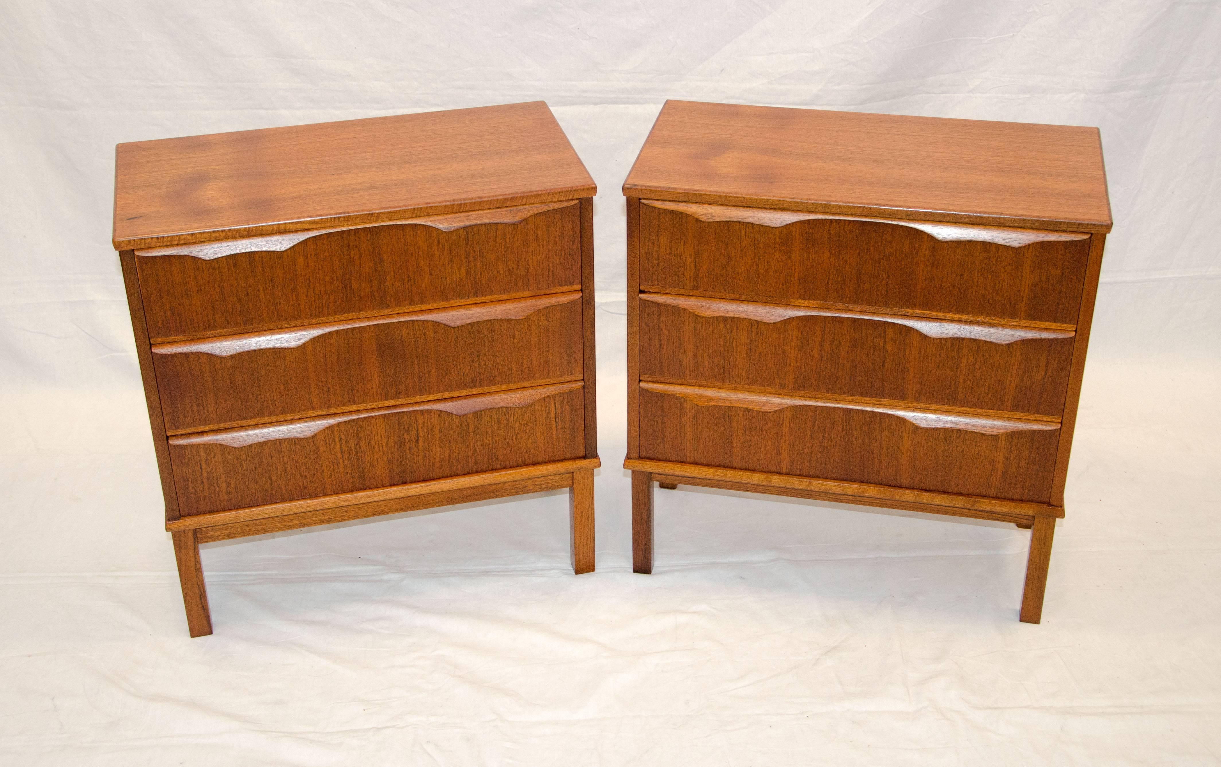  Very nice pair of Danish teak night stands with three storage drawers in each. Each drawer has sculpted handles attached at the top. They are raised off thee floor by 8