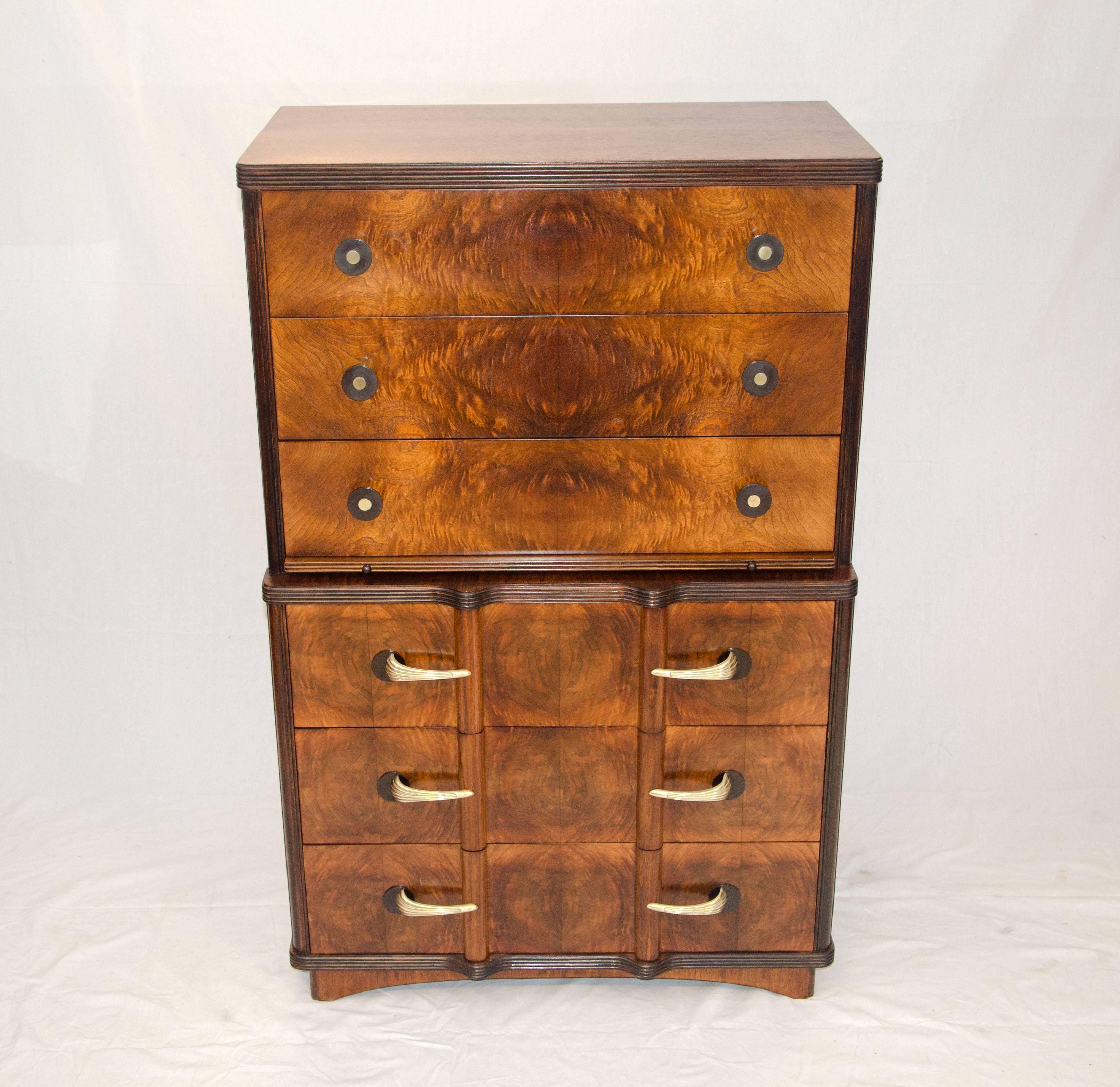  Nice burl walnut highboy dresser that has a few features, each side has a semicircular inlay, there is a pull-out shelf in the center to co-ordinate shirts and sweater outfits, there is a cedar lined bottom drawer for sweater storage. Drawer pulls