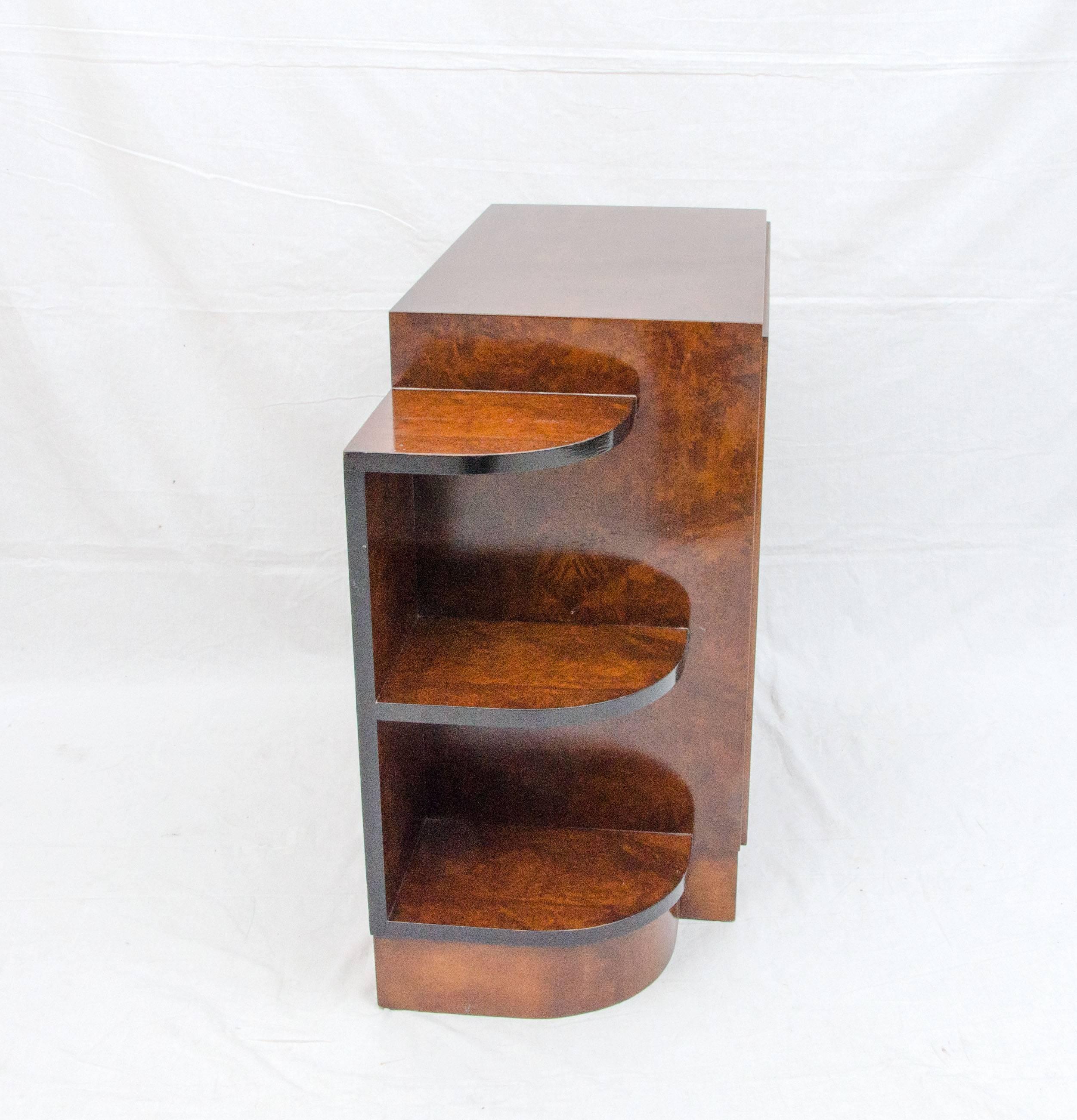 Very nice small shelf cabinet from the Art Deco period in burl walnut with black accents would be a great accent piece in a small space or in a hallway. Could be used for books, magazines, or to display a small collection of items. Curved shelves