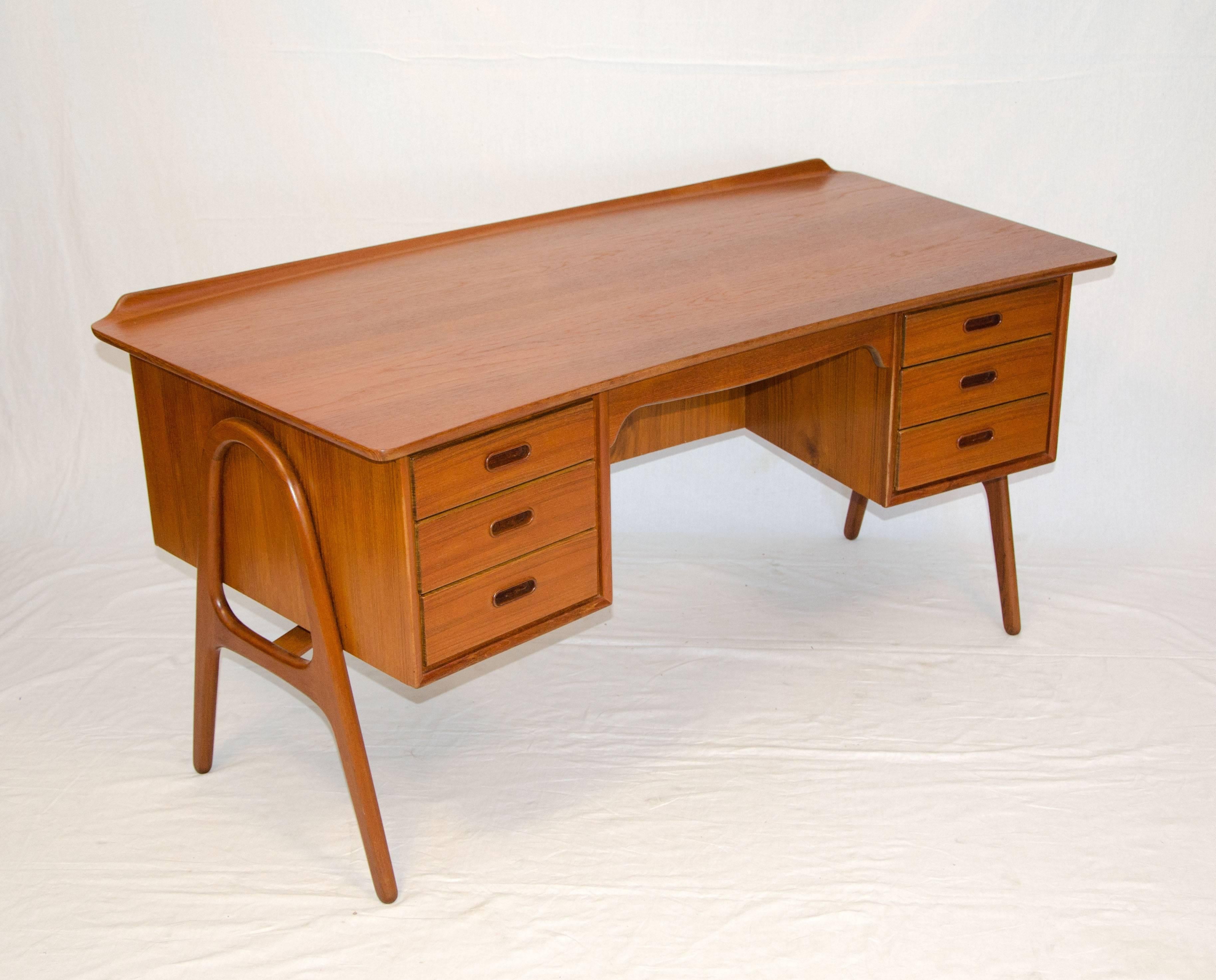 Very nice Danish modern desk marked "Designed by Architect Svend & Madsen" on drawer bottoms. Curved end of desk has a raised gallery to keep paperwork from falling off. Also has a bookcase on the backside. Desk is suspended on two