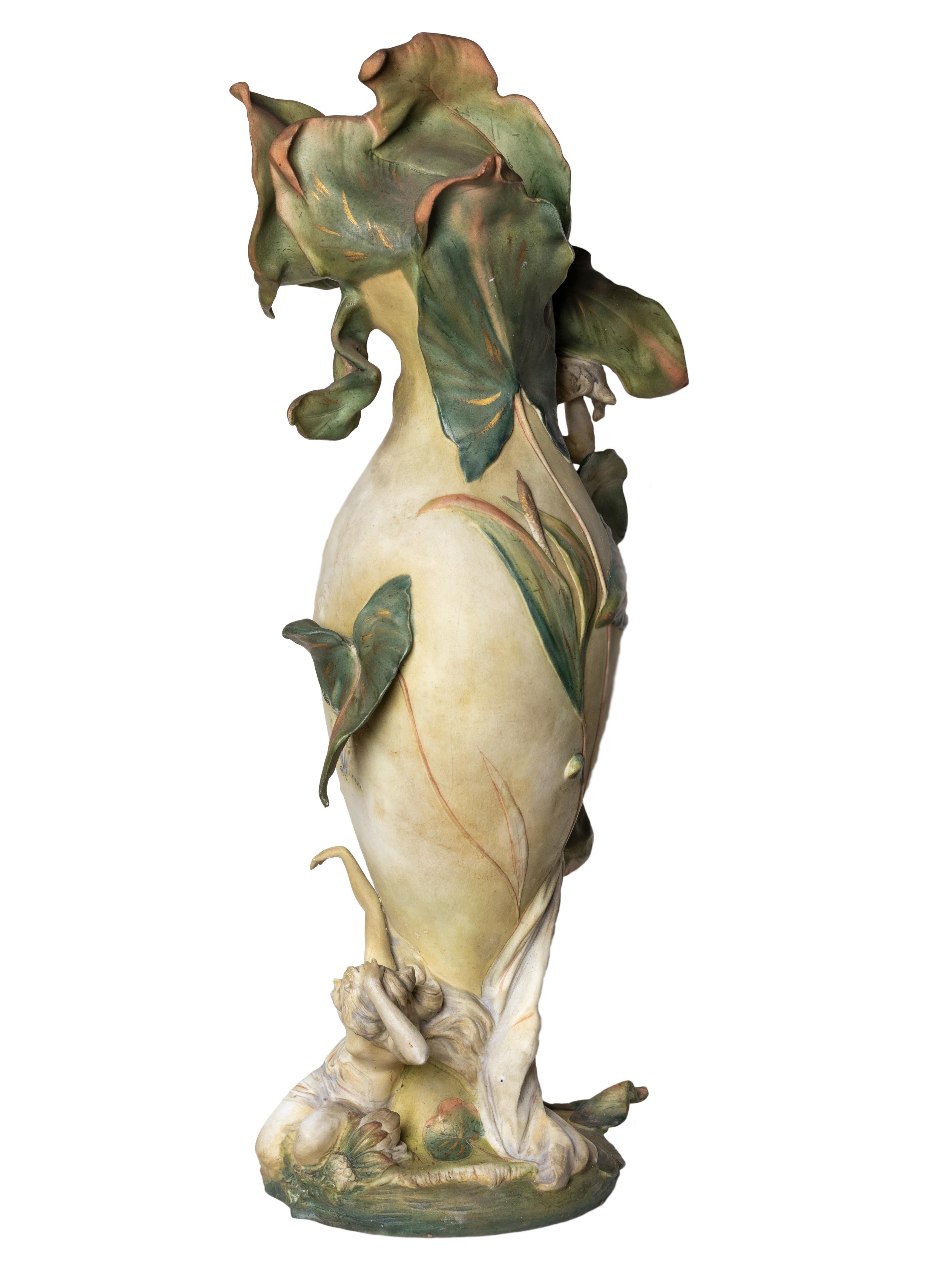 An amazing Jugendstil Style amphora from Rudolstadt, Thuringia hailing from the Triebner Ens Manufacture and the artist Karl Ens Volkstedt. 

A vase decorated with a iris flower form neck and reclining maidens in the upper and lower sections.