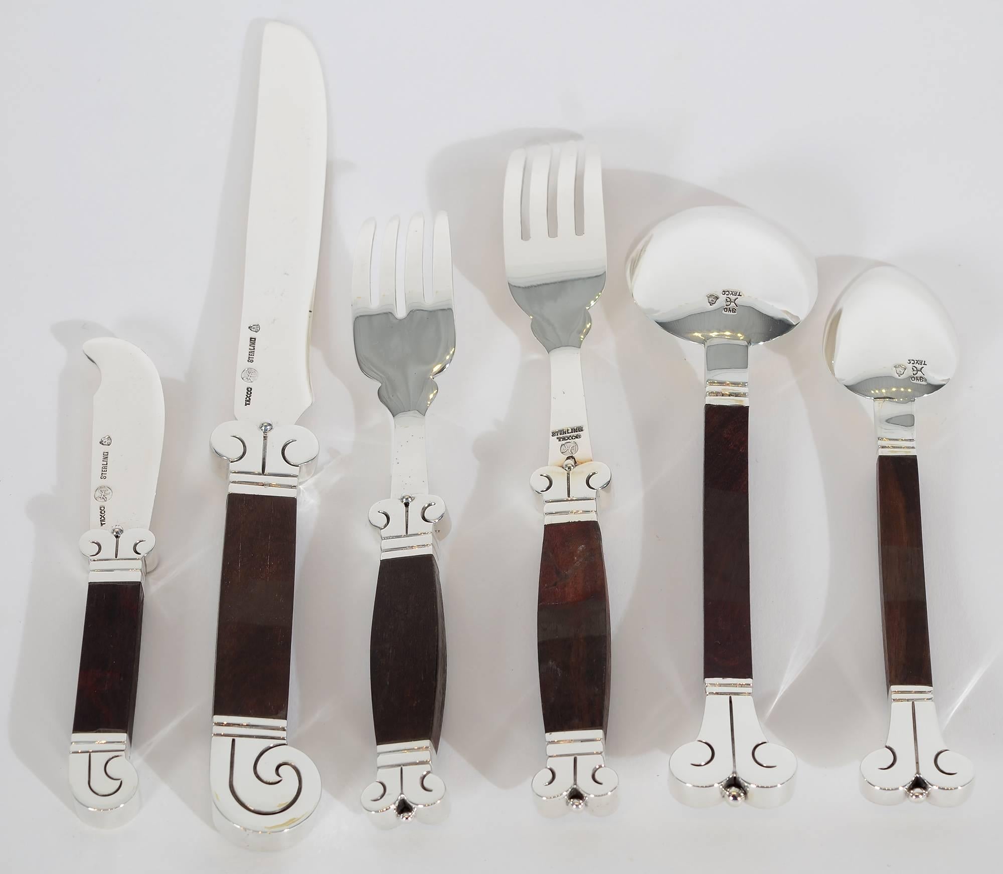 Flatware service for eight in Hector Aguilar's desirable Aztec pattern. It is made of sterling silver and rosewood. All pieces are in excellent condition with 1940s hallmarks.
The set consists of the following pieces:
Eight dinner knives.
Eight