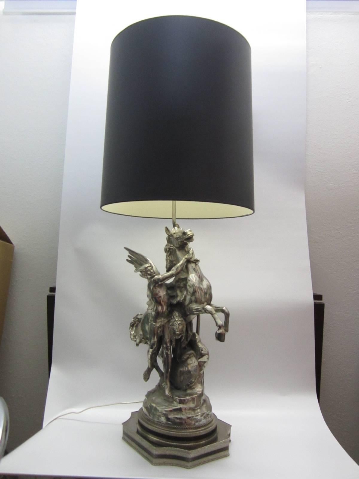 Pegasus table lamp in nickeled metal with black shade. The beautiful Greek Mythical Hero Bellerophon is also handsomely depicted holding Pegasus. Fantastic detail all around and signed on the back. Original condition with a fantastic appearance.
