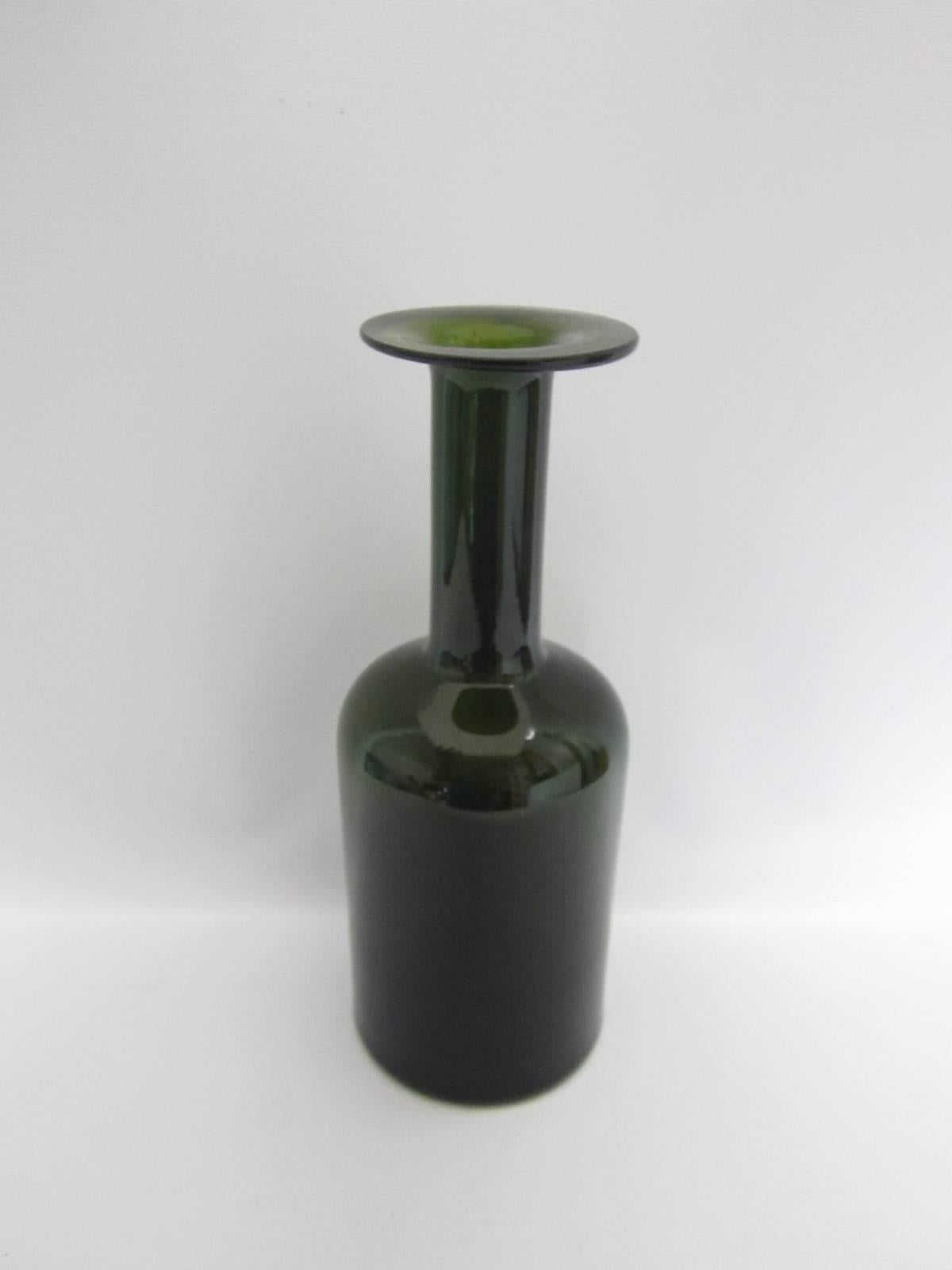 Beautiful green bottle/ vase with thin neck leading to flat top designed by Otto Brauer and manufactured by Holmegaard.