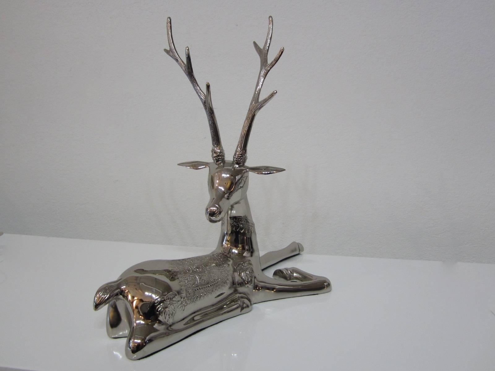 Beautiful Hollywood Regency design nickel plated brass stag in a recumbent position with a lot of detail on the body and ribbed antlers.