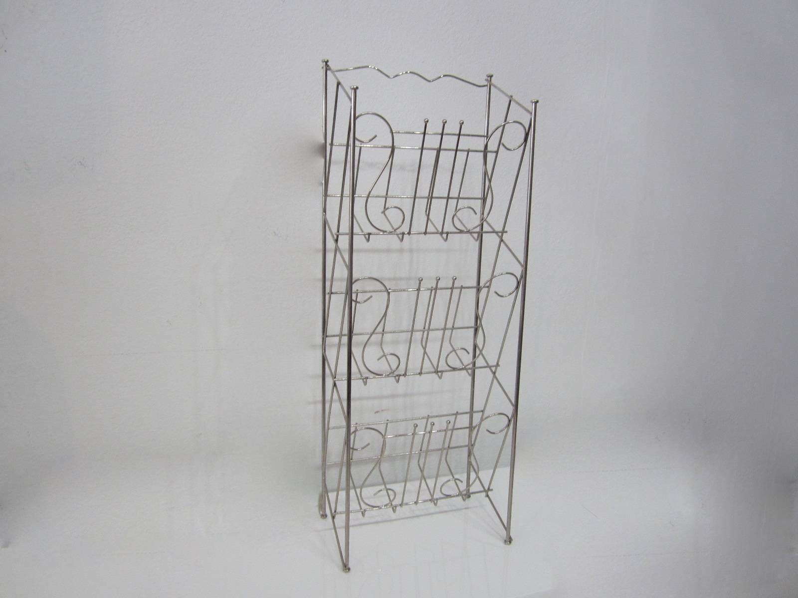 Great three-tier nickel stand with musical notes on it made to hold record albums and books.