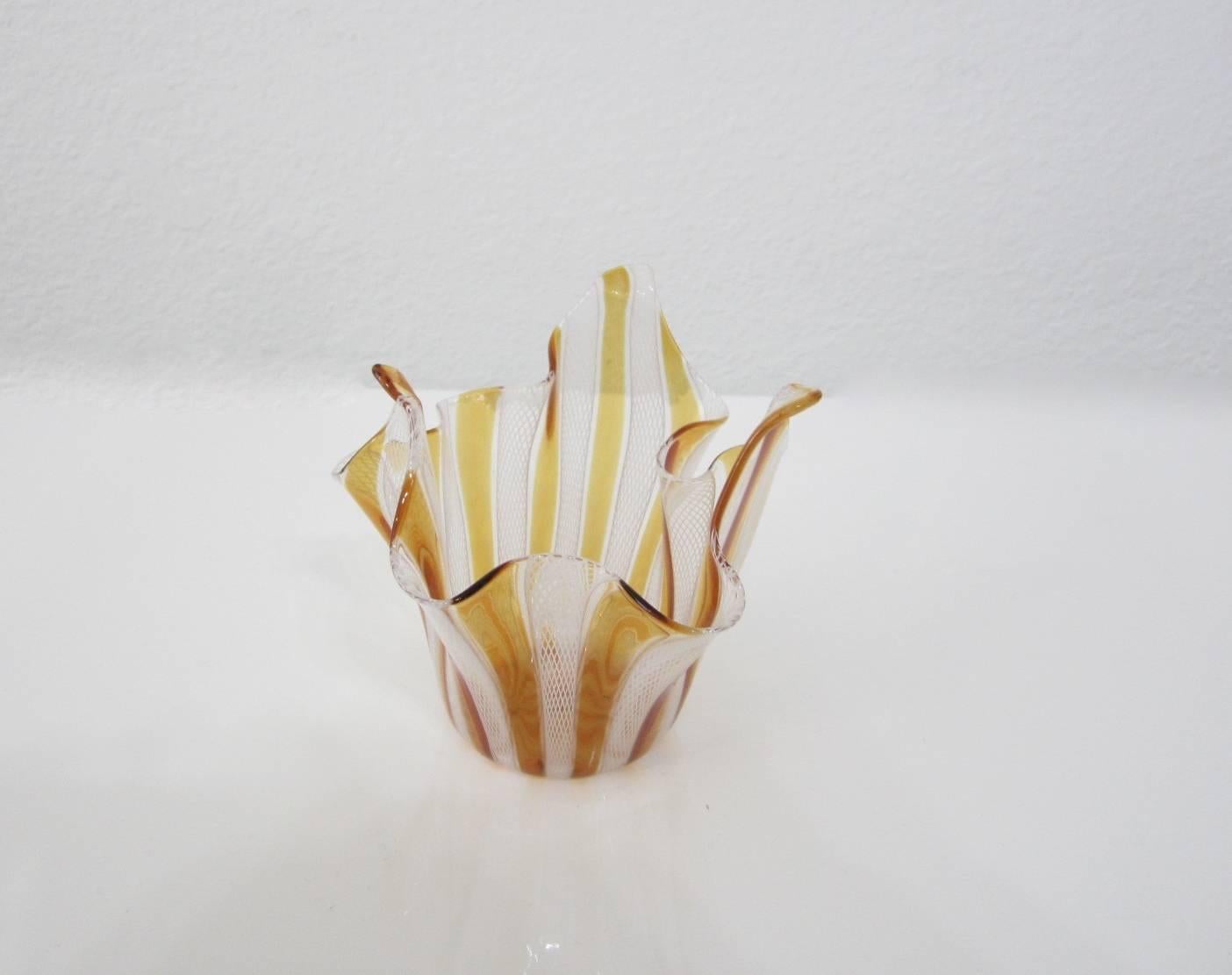 Beautiful handblown Murano glass smaller handkerchief vase in amber and white latticing design. Attributed to Venini.