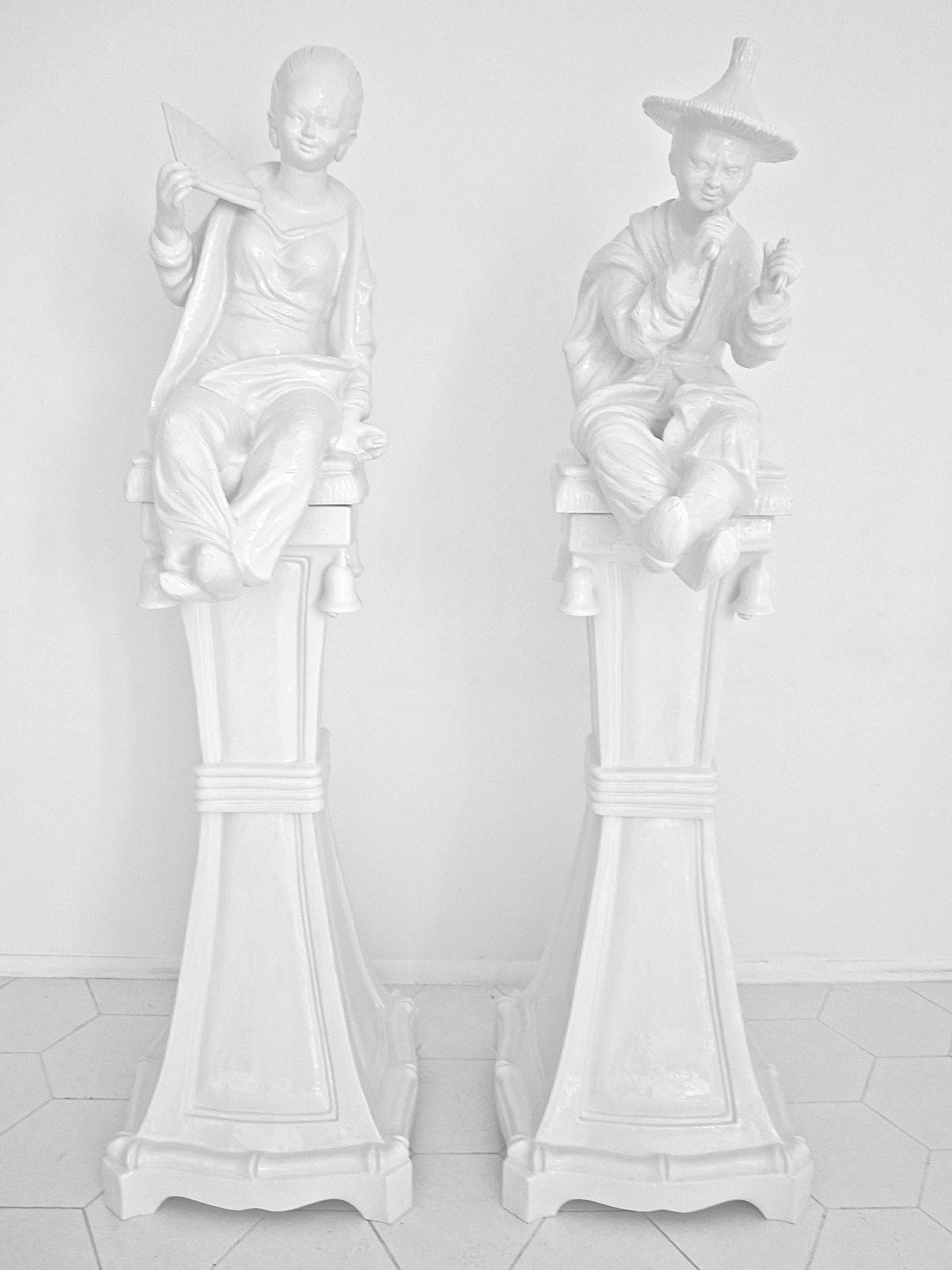Stunning pair of ceramic statues in the chinoiserie style. Made in Italy with the sticker remaining, these statues of a woman and a man Stand almost six feet tall. They come apart in three sections for transport. See closeup images of the exquisite