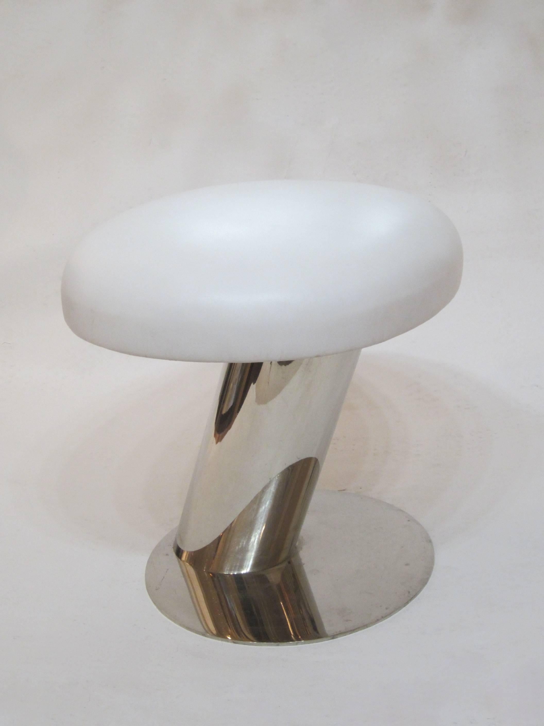 Exquisite stool by Karl Springer with a cantilevered polished steel truck and solid steel disk base. The white marine-leather cushion is oblong and the Springer label is on the frame under the cushion.
