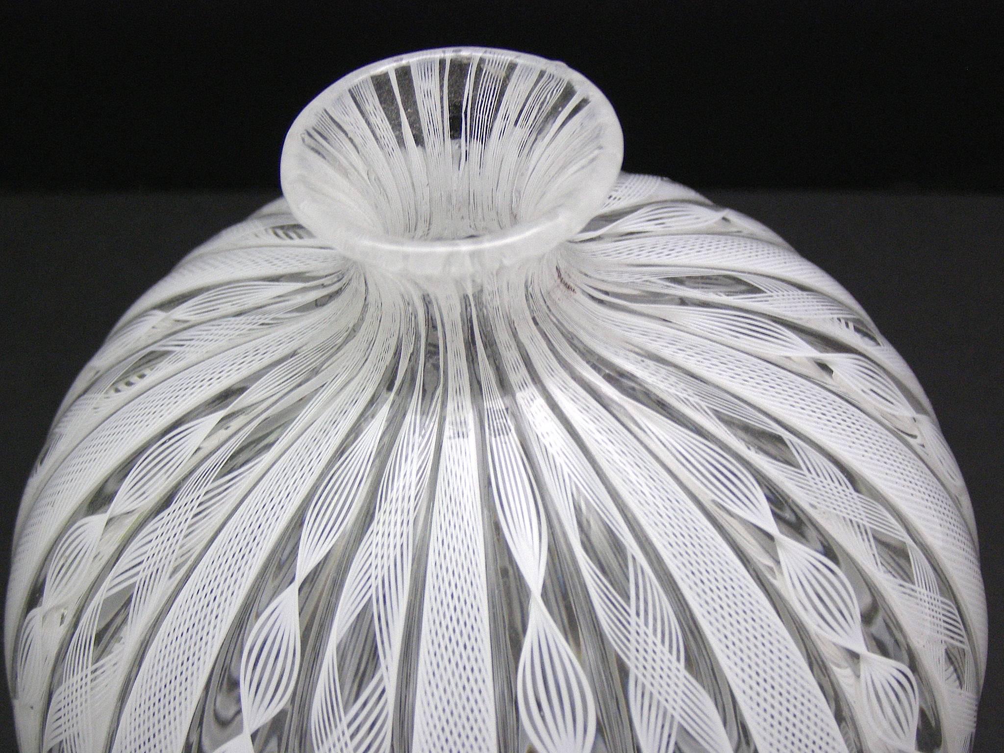 Beautiful handblown Murano glass vase/vessel with gorgeous intricate caned lattimo and latticino work in white. Finley blown and wonderful to the touch. Great alone and also with a small bunch of flowers in it.