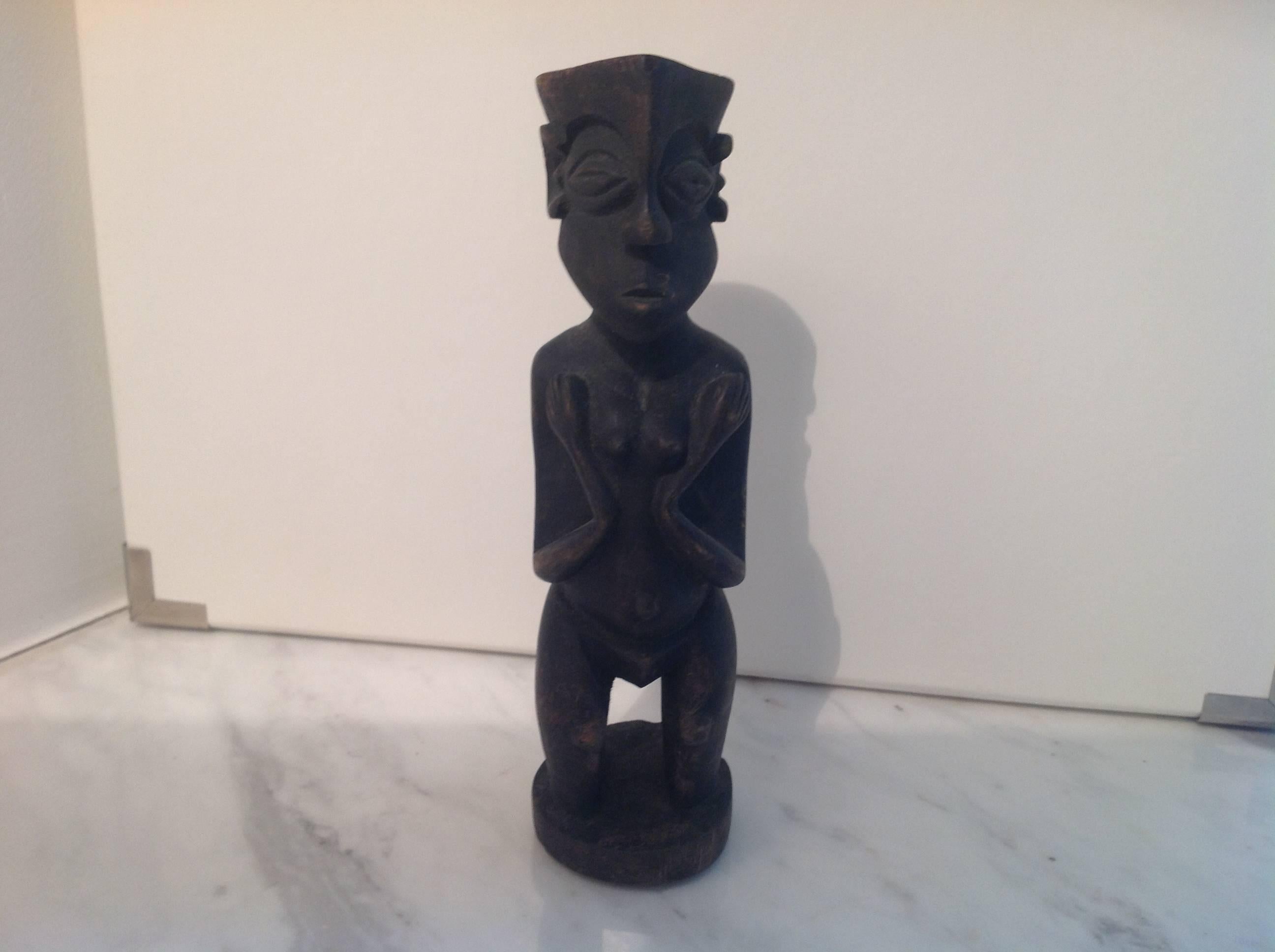 Carved wood figure purchased at market in Mali, West Africa. Scooped top for use of  incense or to hold a treasured possession including tobacco's etc. Uncertain of the tribe this piece descends from but it is heavily yet gently worn and soft to the