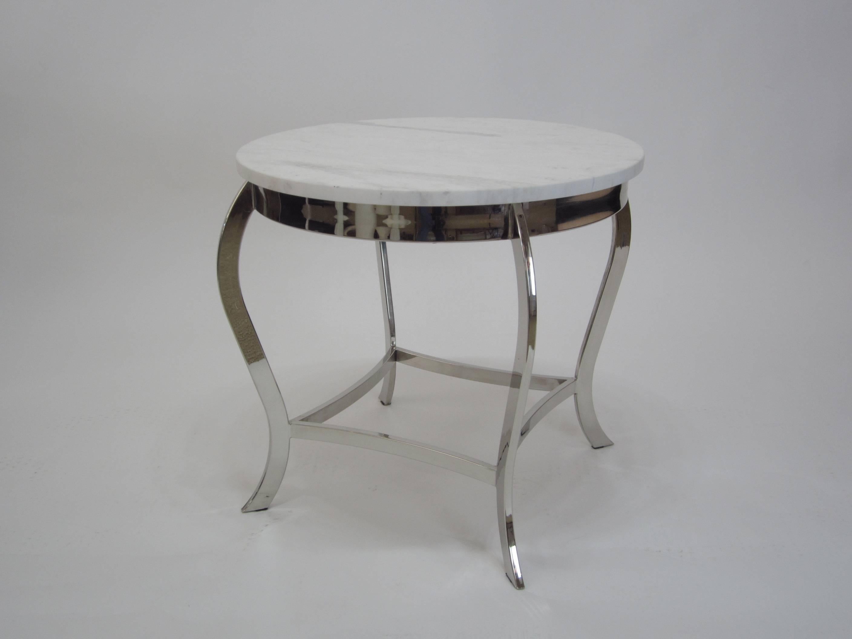 Beautiful side table in nickel with carrara marble top. The matte grey and white carrara marble top is perfectly juxtaposed with the sparkling polished nickel frame. Great in a classical room setting as well as in a contemporary setting.