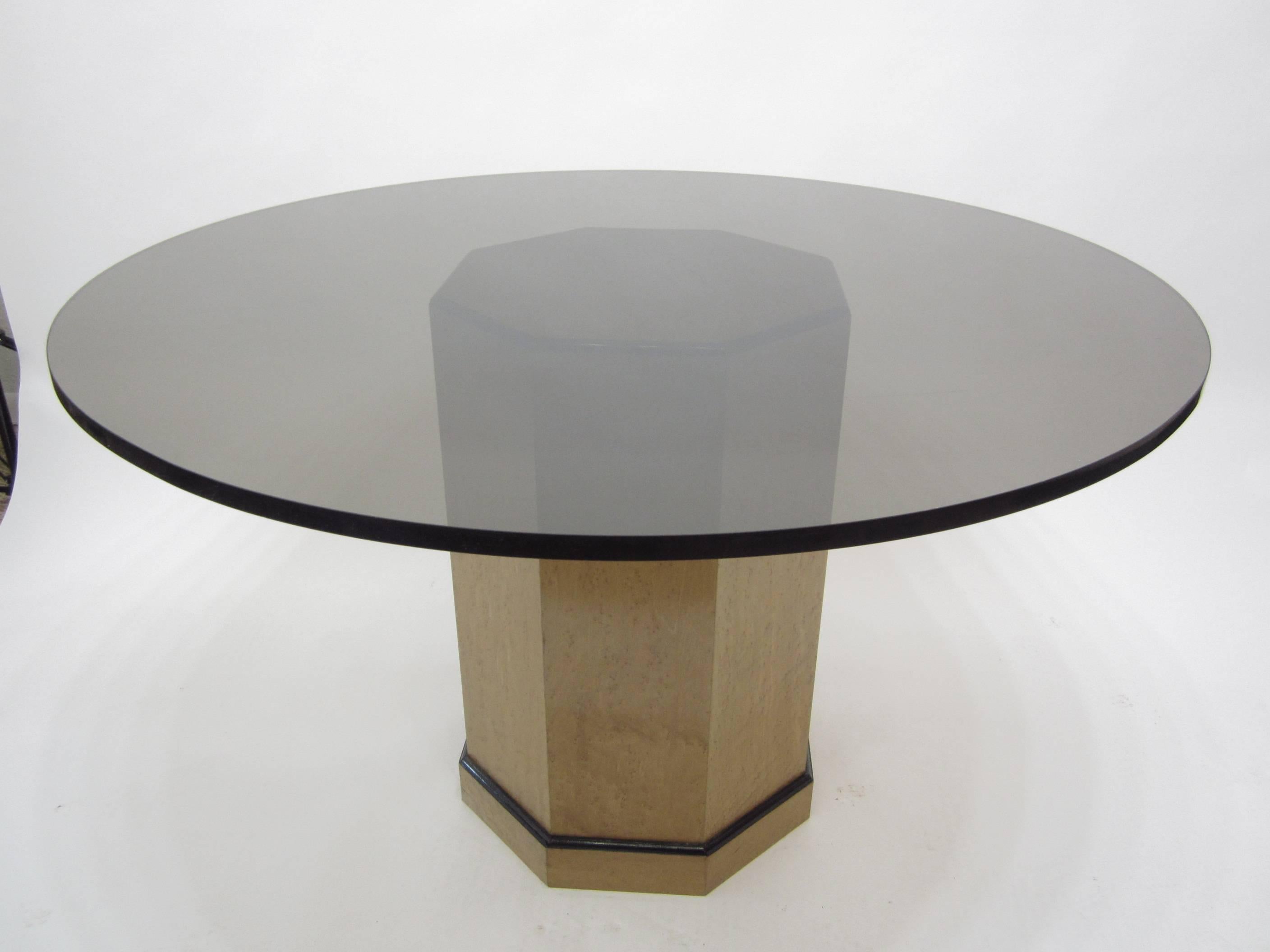 Centre pedestal dining table with maple octagonal base trimmed in black. A three-quarter inch amber circular glass top currently adorns the table which can easily be replaced if desired. Natural wear on base and flea-bite nicks and scratches to the