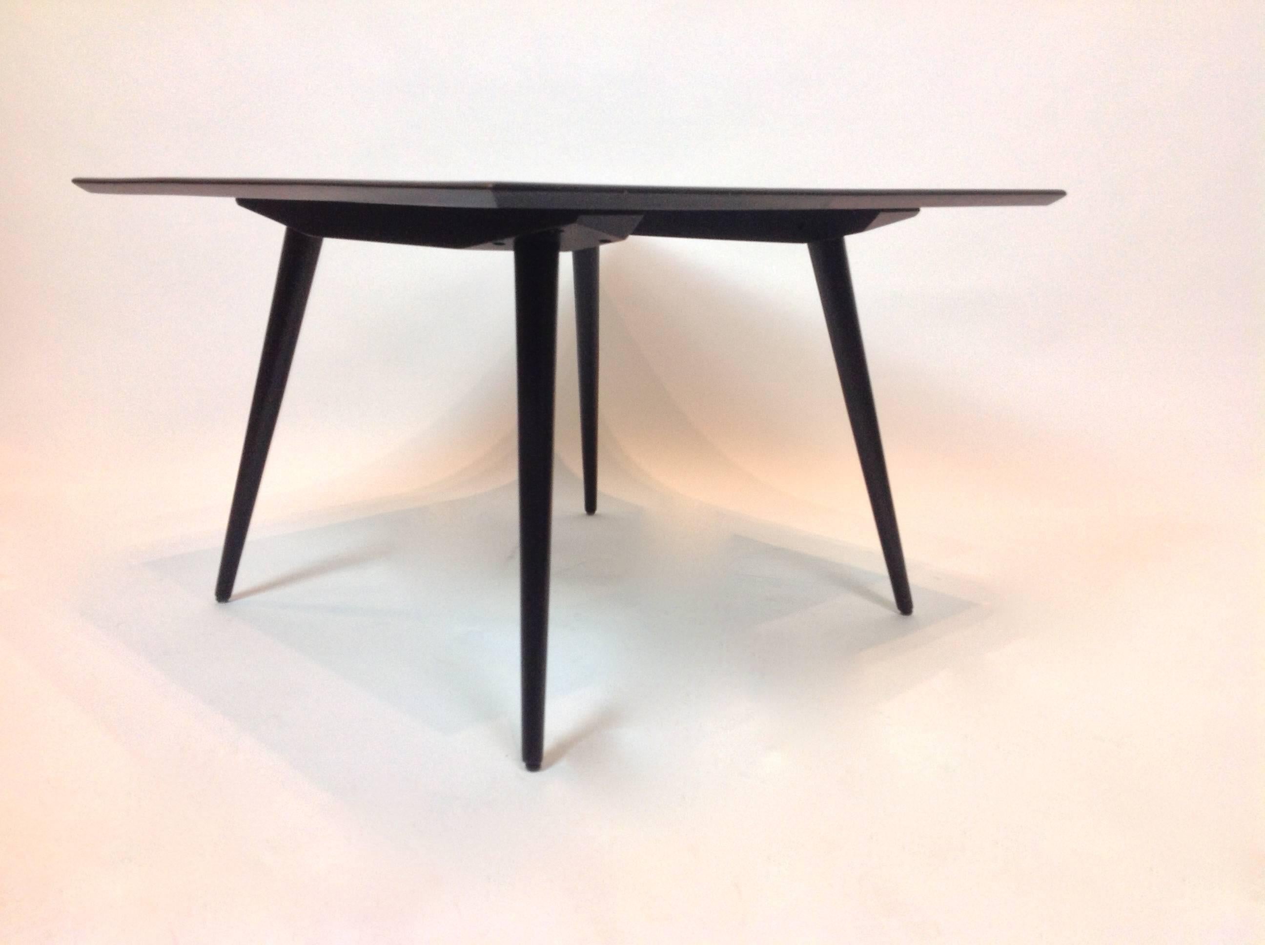 Elegant in its simplicity, this side table was designed in the 1950s by Paul McCobb for the Planner Group. Made of solid maple wood finished with matte black paint. Table is a perfect square with finely tapered legs and an under-bevelled top surface.