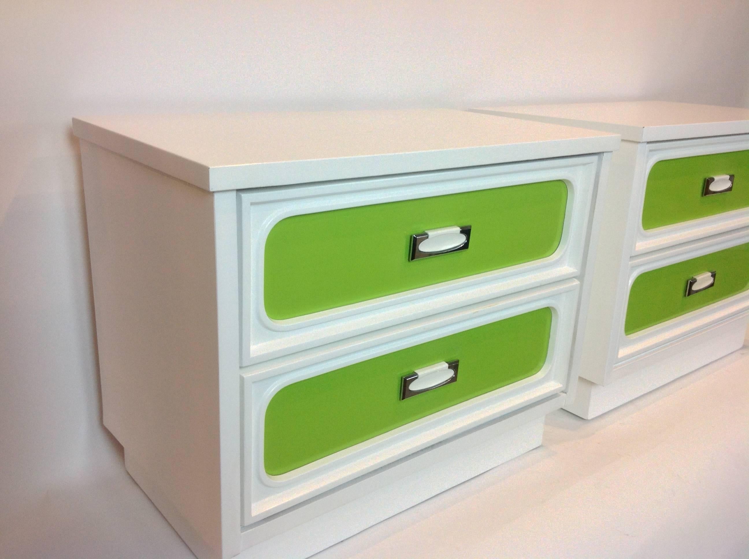 Pair of side tables or beside chests with two drawers each that have interchangeable colored plastic front panels lime green and lemon yellow.