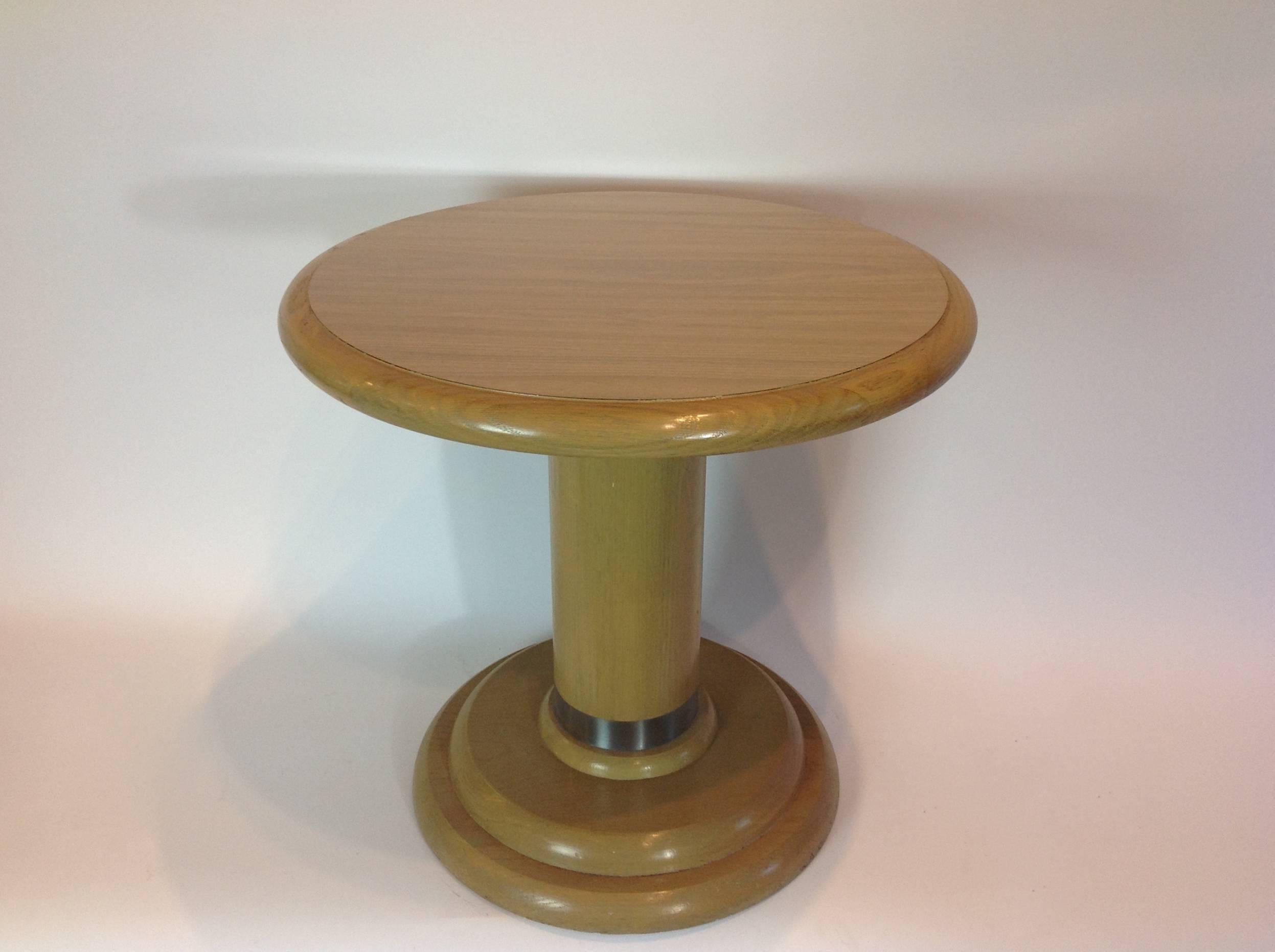 Side table fashioned in the Art Deco style with steel banding, wood, and a laminate top.