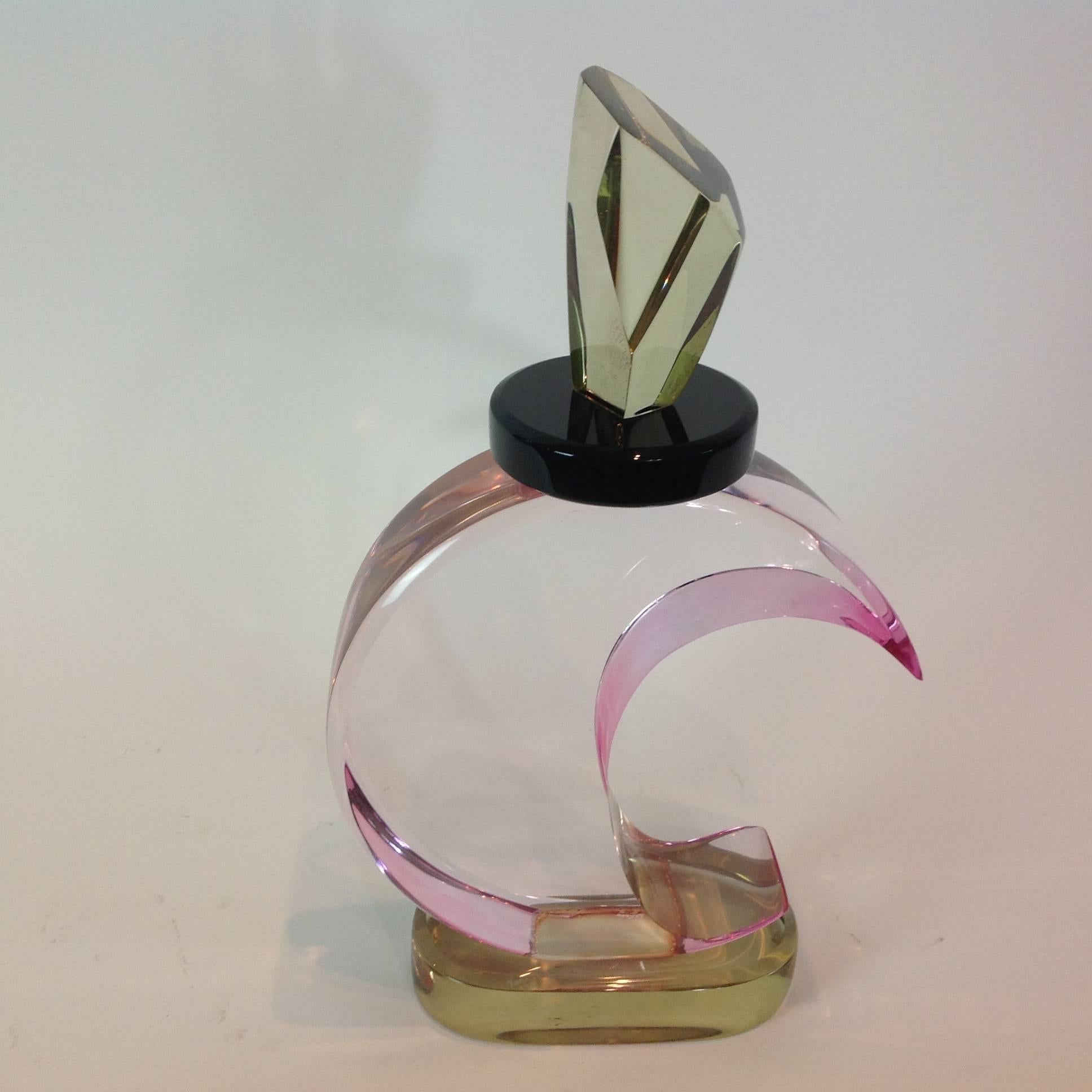 Fantastic sculpture of smooth Lucite parts formed in the shape of a perfume bottle. Soft pink and amber colors mixed with black and clear; signed.