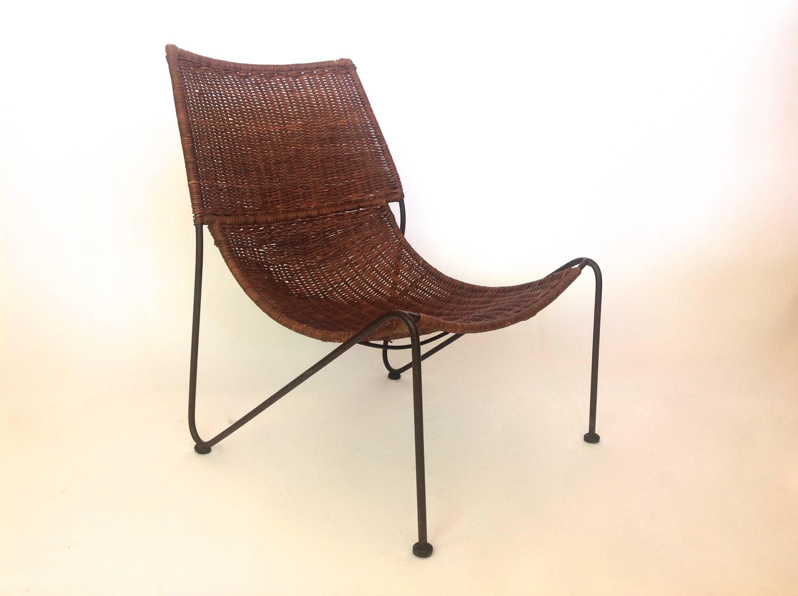 Wonderful wide-weave wicker chair with a midcentury black iron hairpin-leg frame.