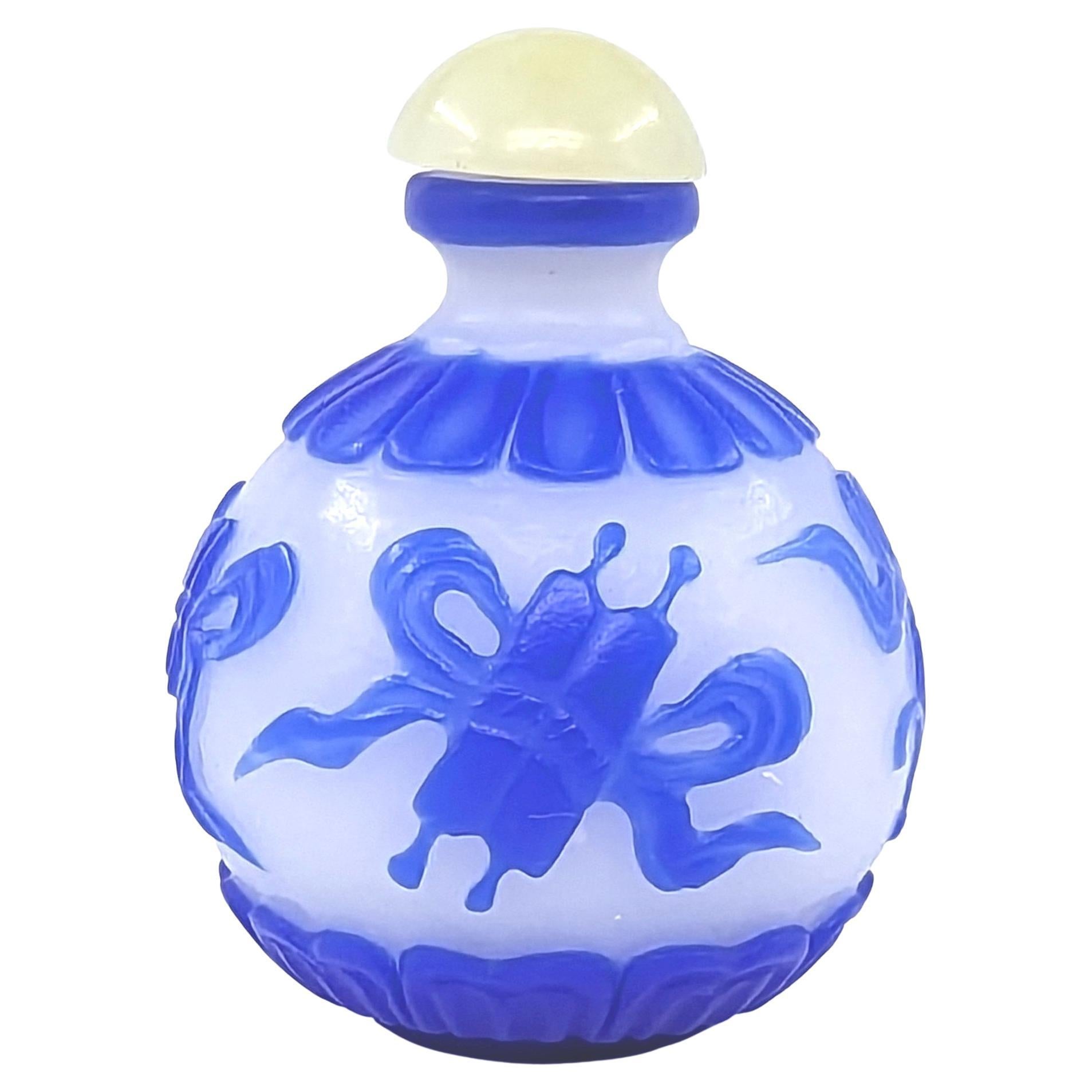 Chinese Blue Glass Overlay Globular Snuff Bottle Carved Buddhist Treasures 20c For Sale