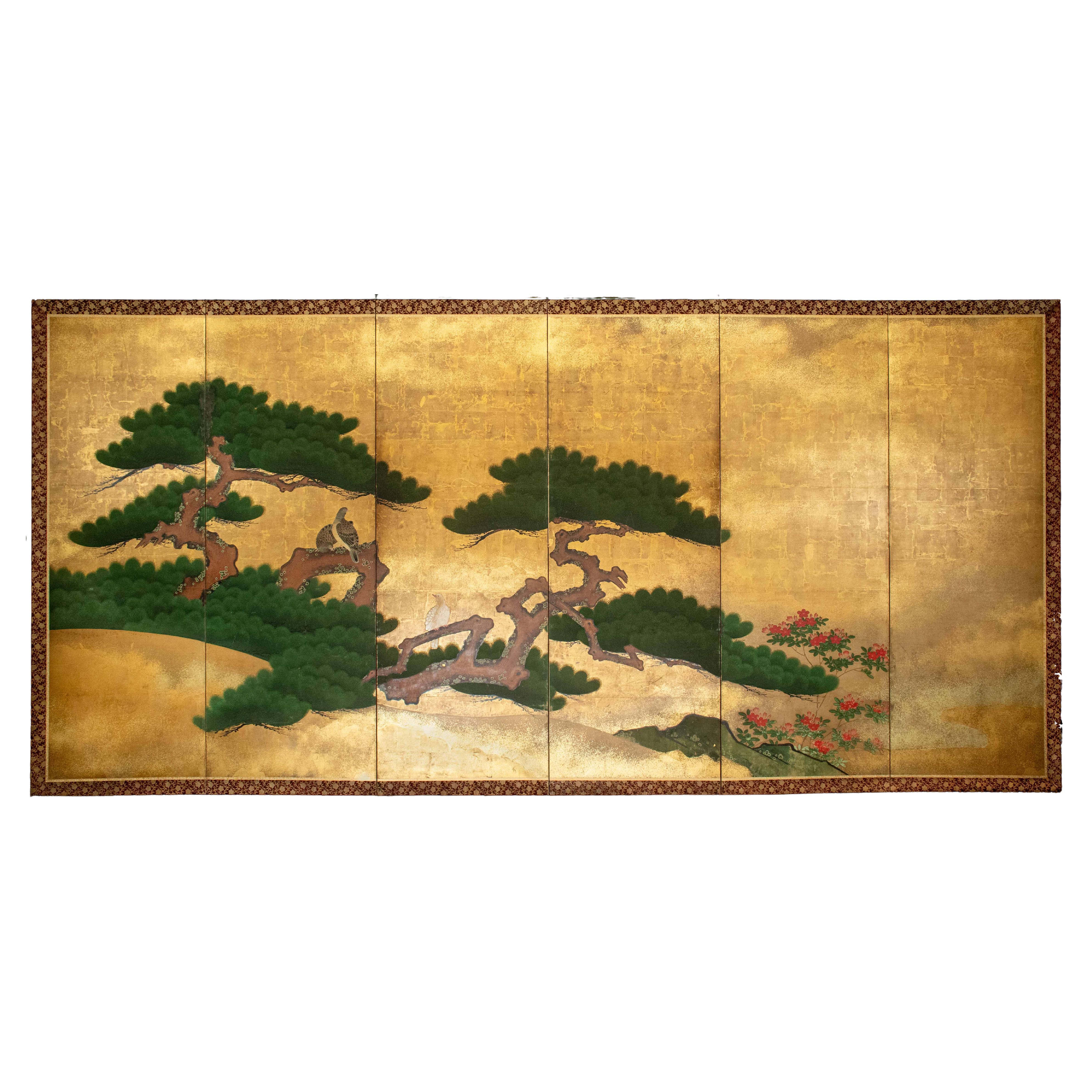 A pair of six-panel folding screens depicting two pine trees (matsu) en vente