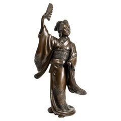 A Japanese bronze sculpture depicting a dancer with fan