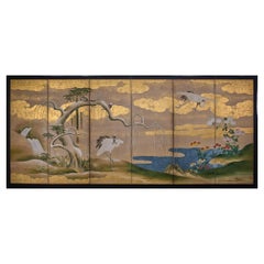 A six-panel folding screen from the Kano School, gilded with gold leaf, depicting a pair of red crows