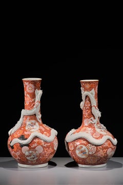 A pair of Imari vases with relief dragons, signed Hichozan