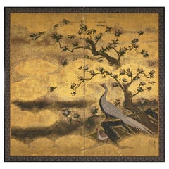 A two-panel gold-leaf screen depicting a pair of pheasants beneath a flowering tree