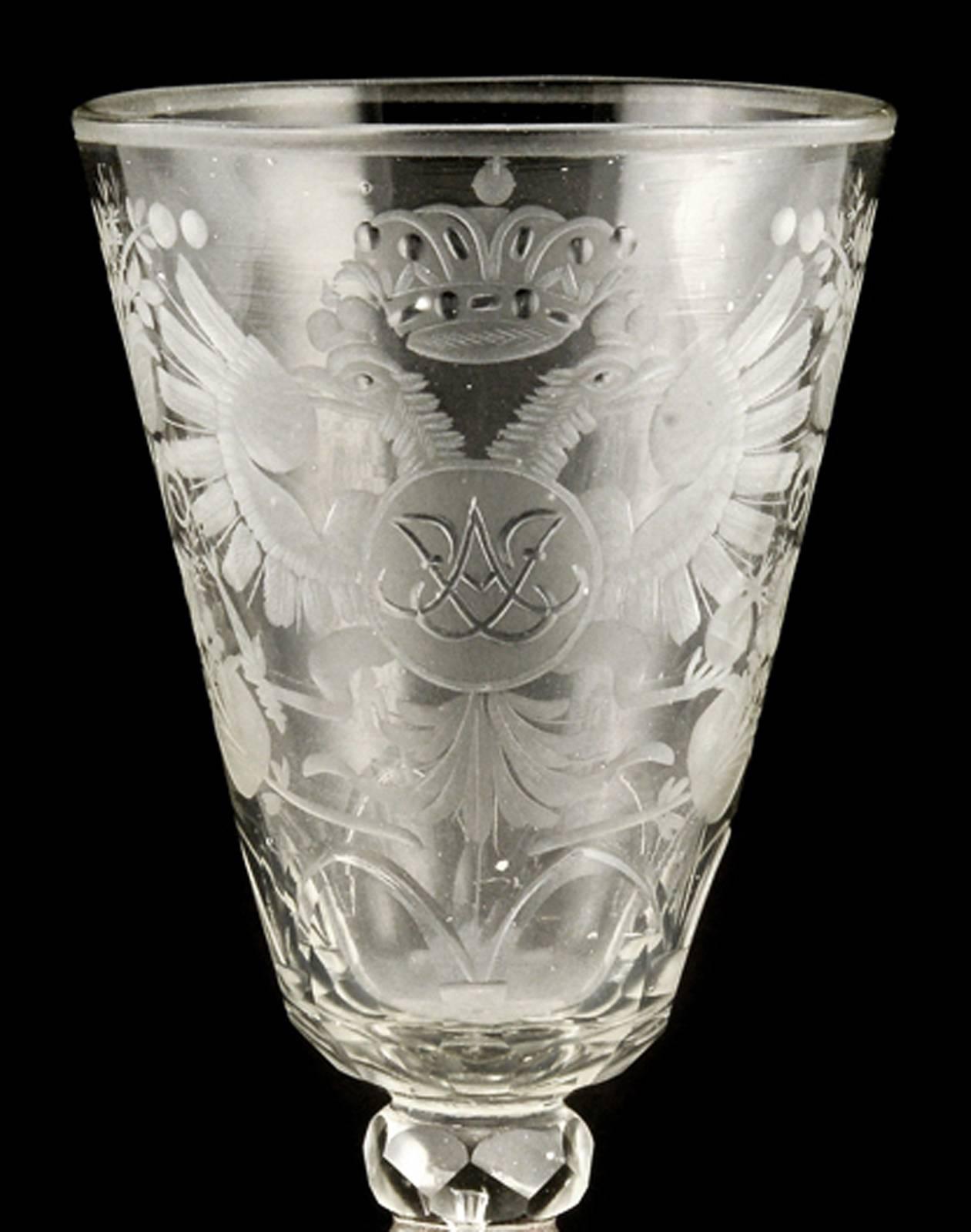 A rare Russian wine goblet, Lamburg (Yamburg) or Petersburg glassworks, circa 1730-1740. Handblown of colorless glass, the tapering bowl finely engraved with the double-headed Imperial eagle with the mirror cypher of Empress Anna Ioannovna (r.