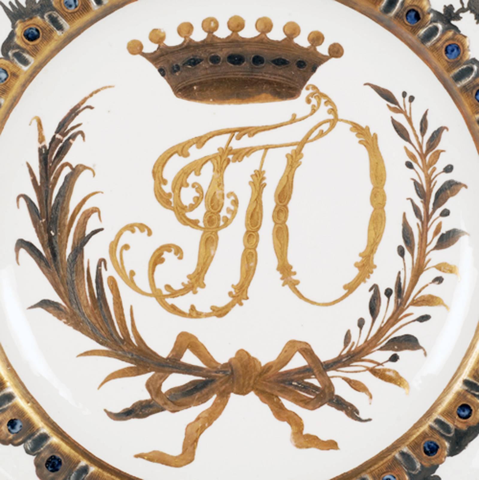 An extremely rare Russian porcelain plate from the Orlov Service, Imperial Porcelain Factory, circa 1763-1770. Circular with shaped border, the cavetto decorated with interlaced and crowned gilt Cyrillic monogram GGO beneath a nine-pointed Count’s