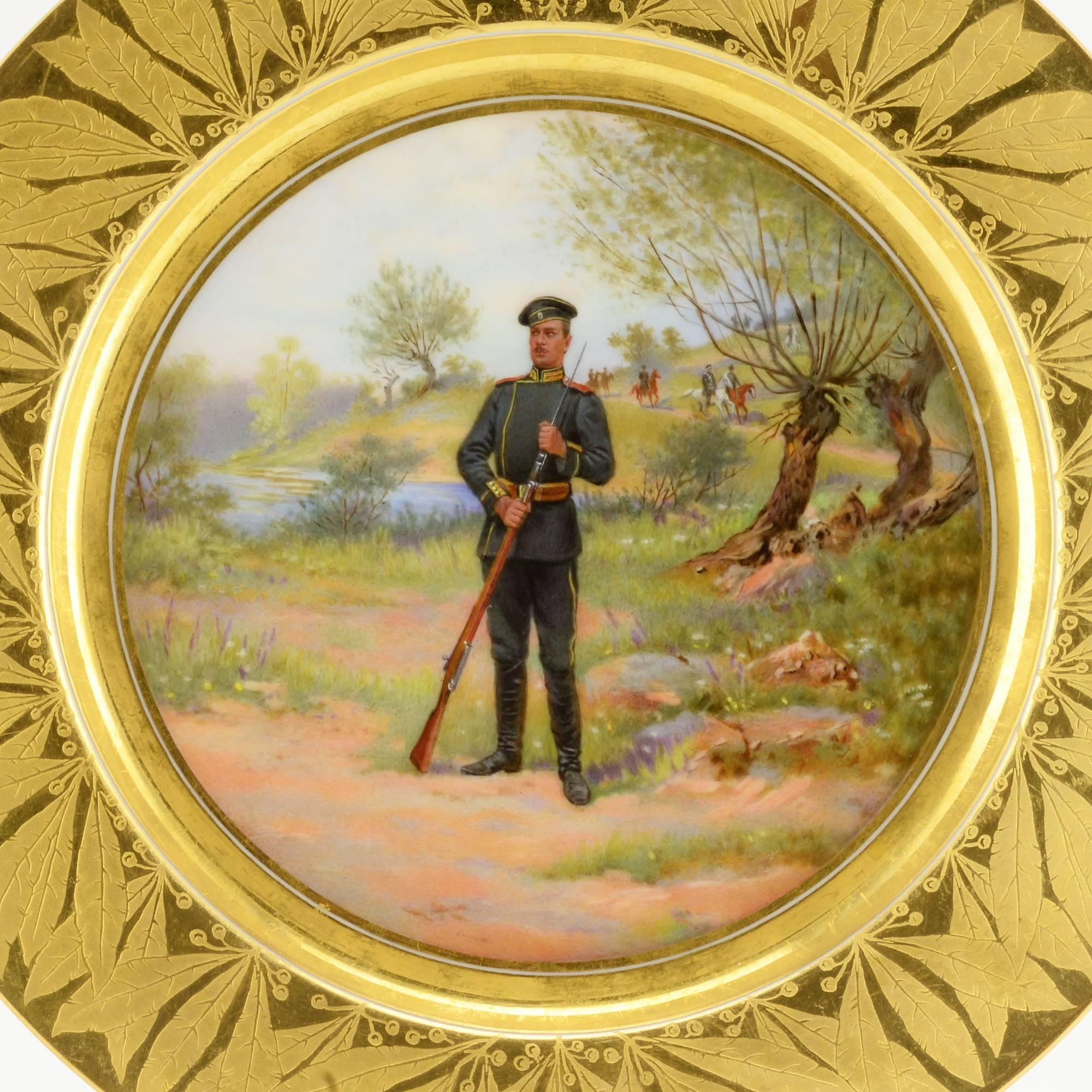 A Russian plate from the military service begun in 1907, Imperial Porcelain Factory, ST Petersburg, 1910. Circular, the cavetto painted with a view of a soldier of the Volinsky, or Volhynian Life-Guards Regiment (Волынский лейб-гвардии полк) in