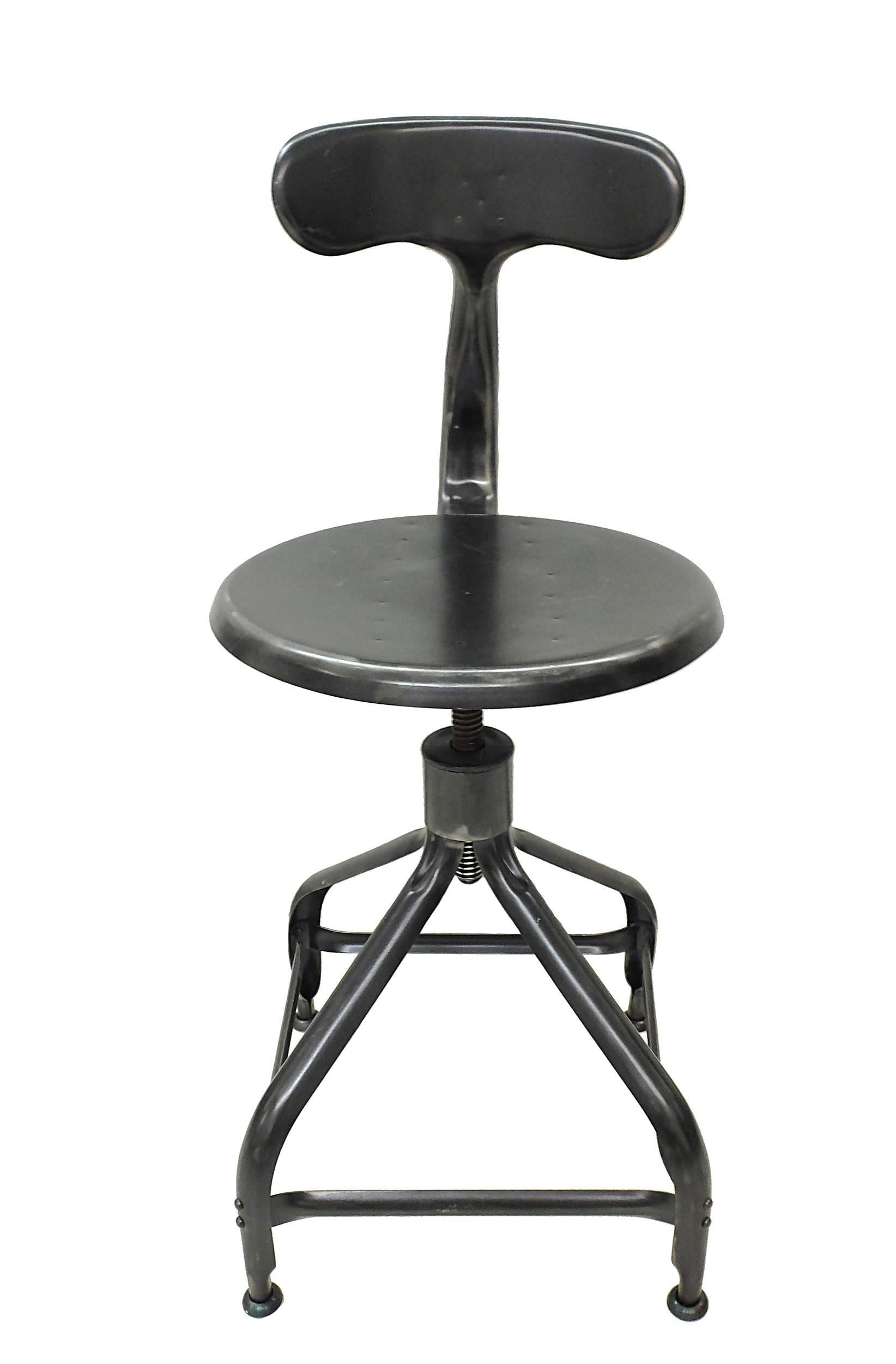 Industrial iron working chair with backrest adjustable sit screwing a thick screw. Four legs. Six available. Price is intended to each single one, France, 1945.