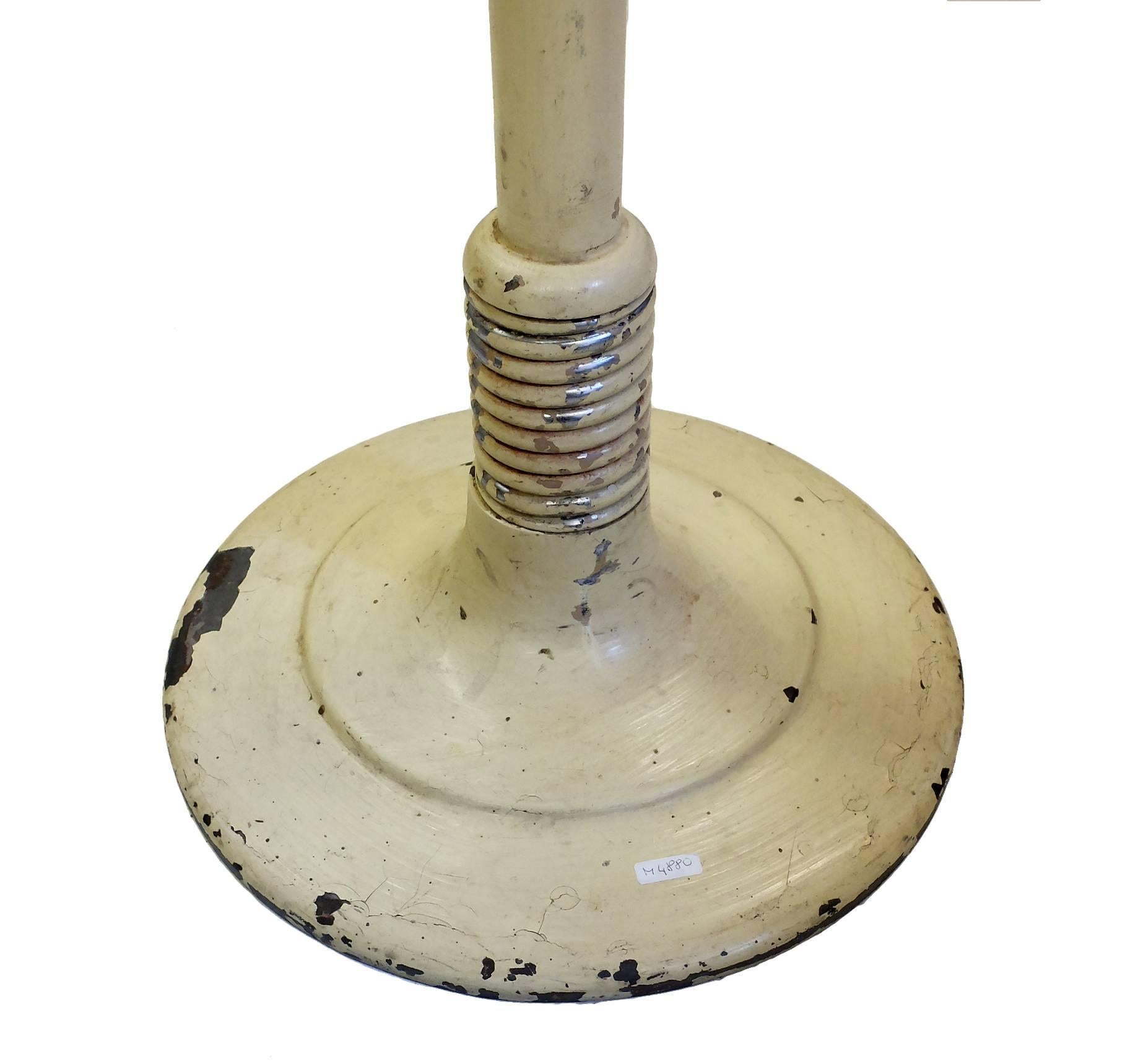 An unusual adjustable cast iron dentist’s stool with a big metal spring, weight motion. Original white color.