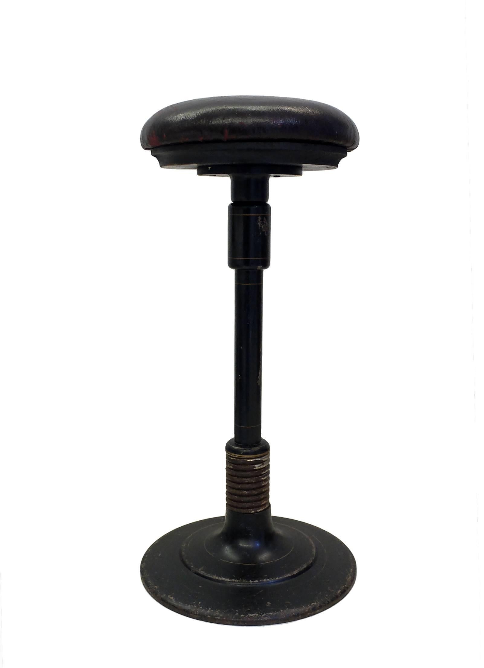  An unusual adjustable cast iron dentist’s stool with a big metal spring, weight motion. Original black color. France, circa 1890.