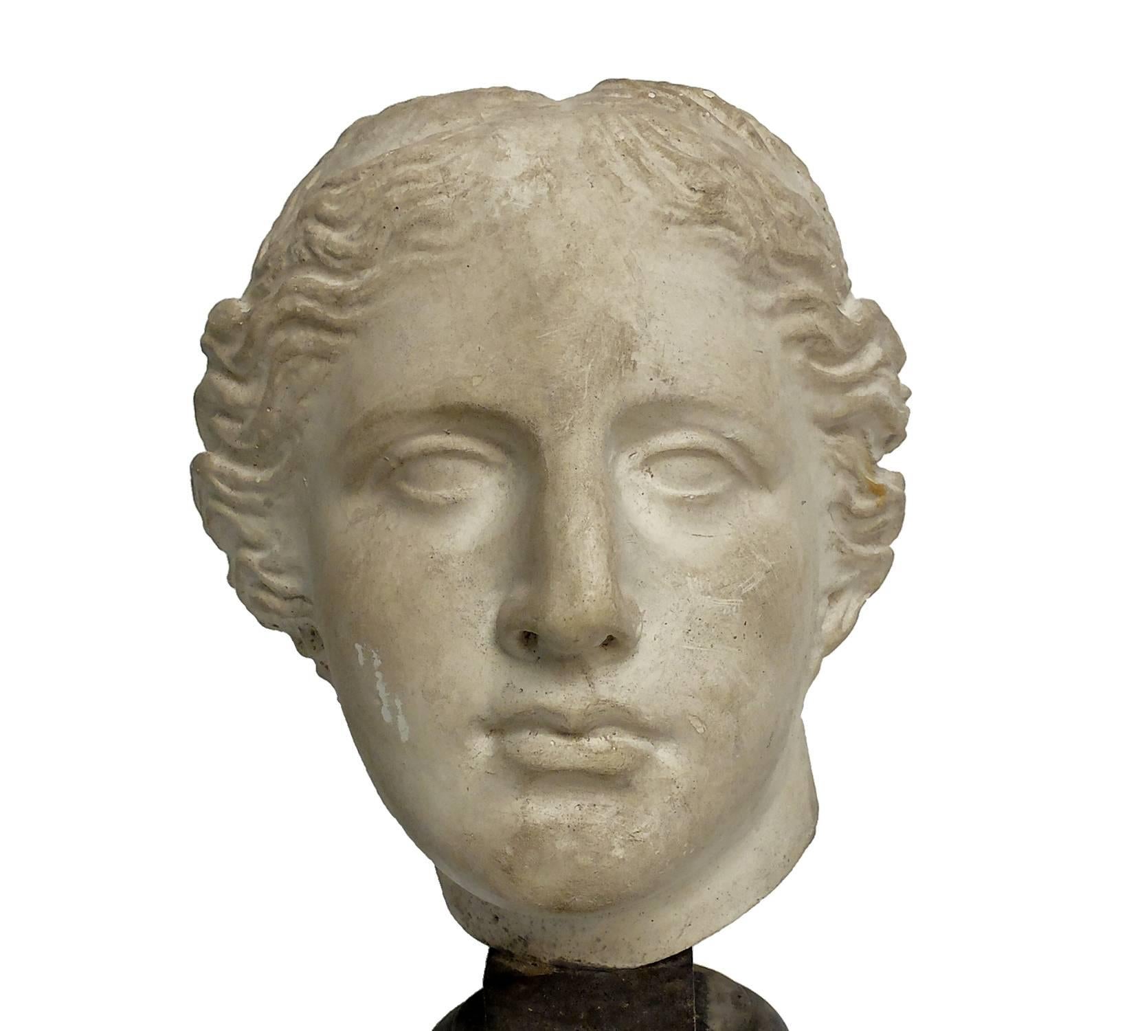Over the wooden, black painted base is set the superb cast of Nike’s head. Cast for drawing teaching in academy, Italy, circa, 1890.