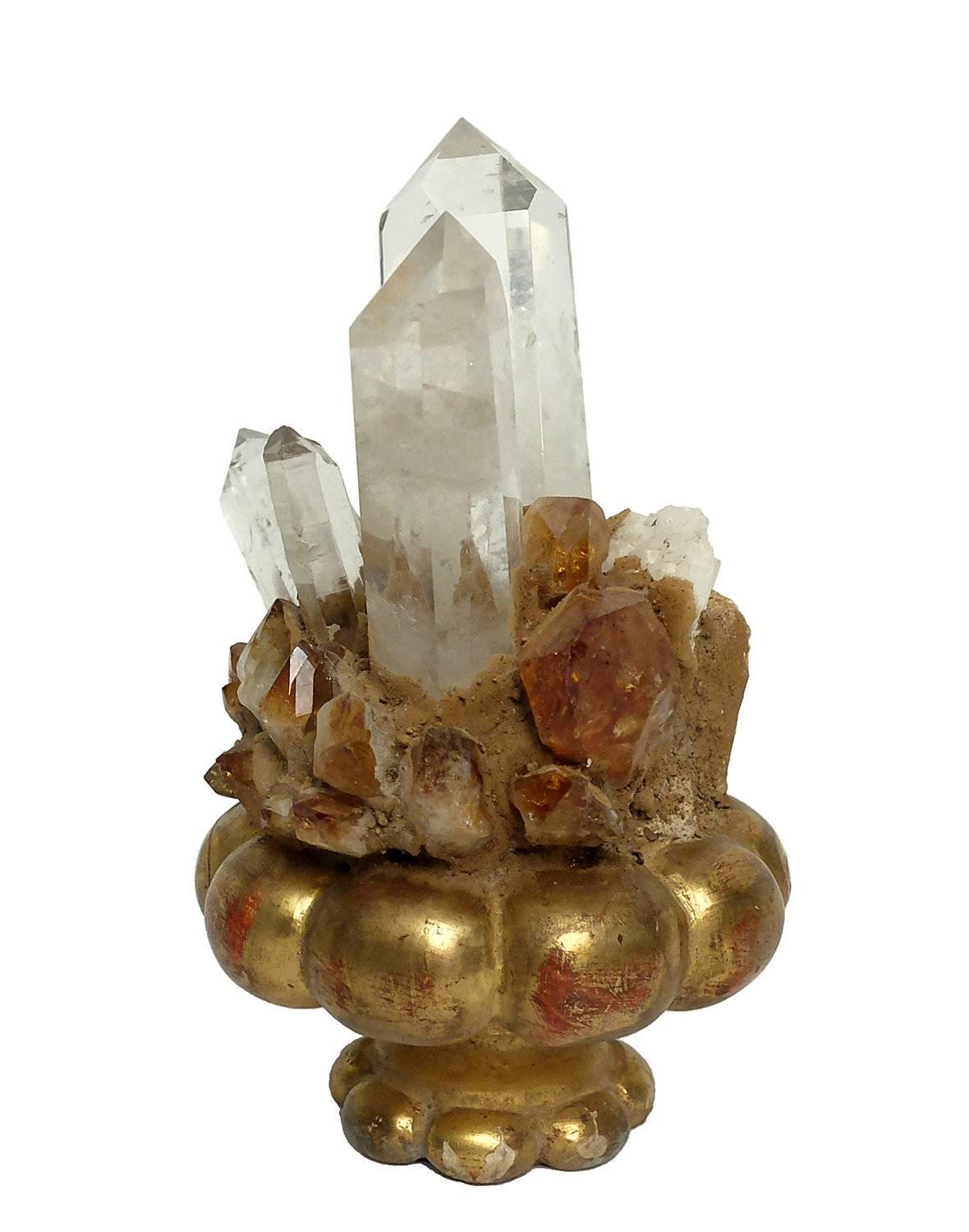 A Naturalia mineral specimen a rock crystals and citrine quartz druze, mounted over gold-plated carved wooden base.