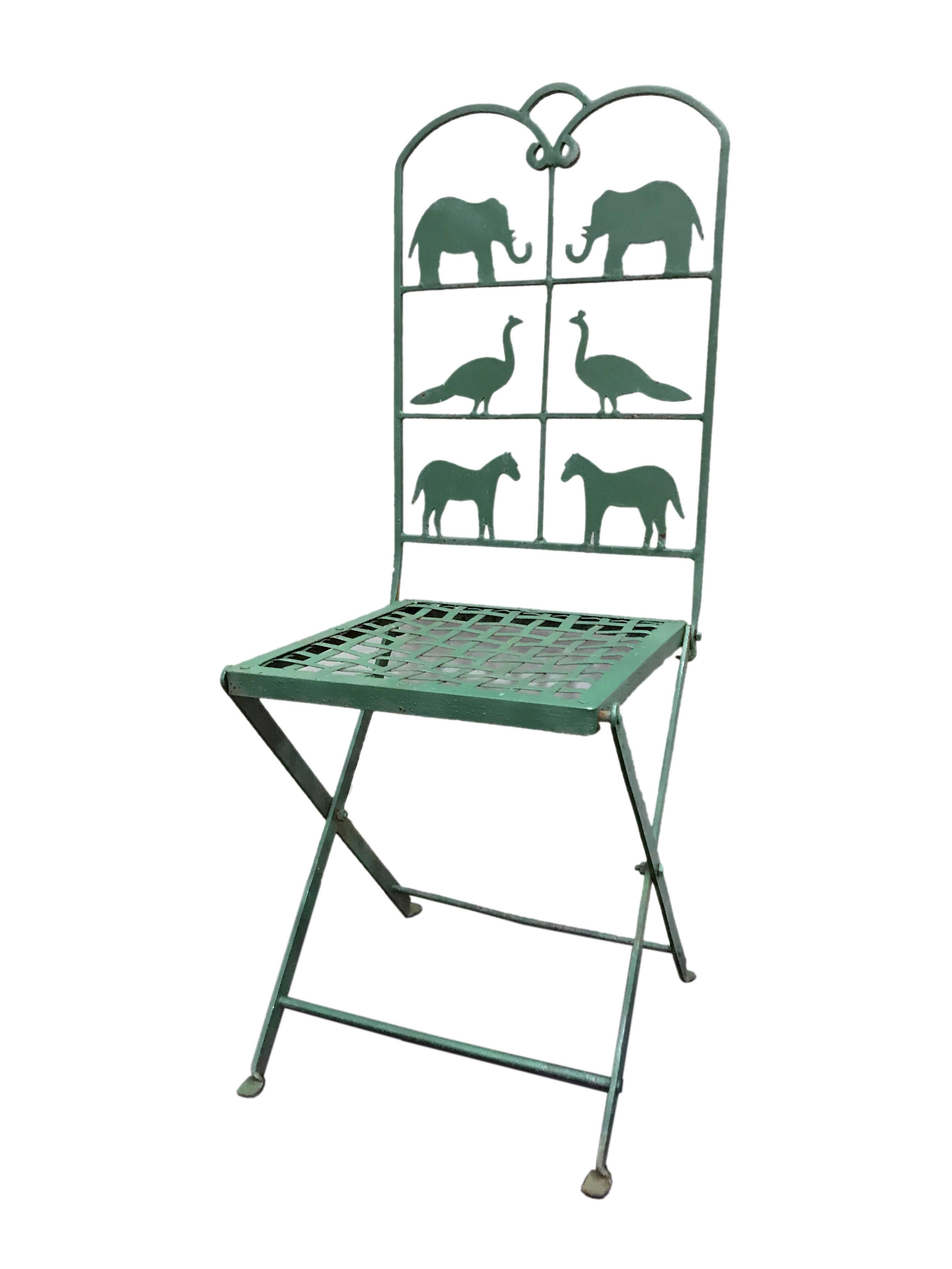 Set of four painted iron outdoor foldable chairs, green painted.
Characterized by the beautiful back with, in each one, a pair of elephants, a pair of peacocks and two horses.
USA, circa 1900. Sold as a set, not separately.
    