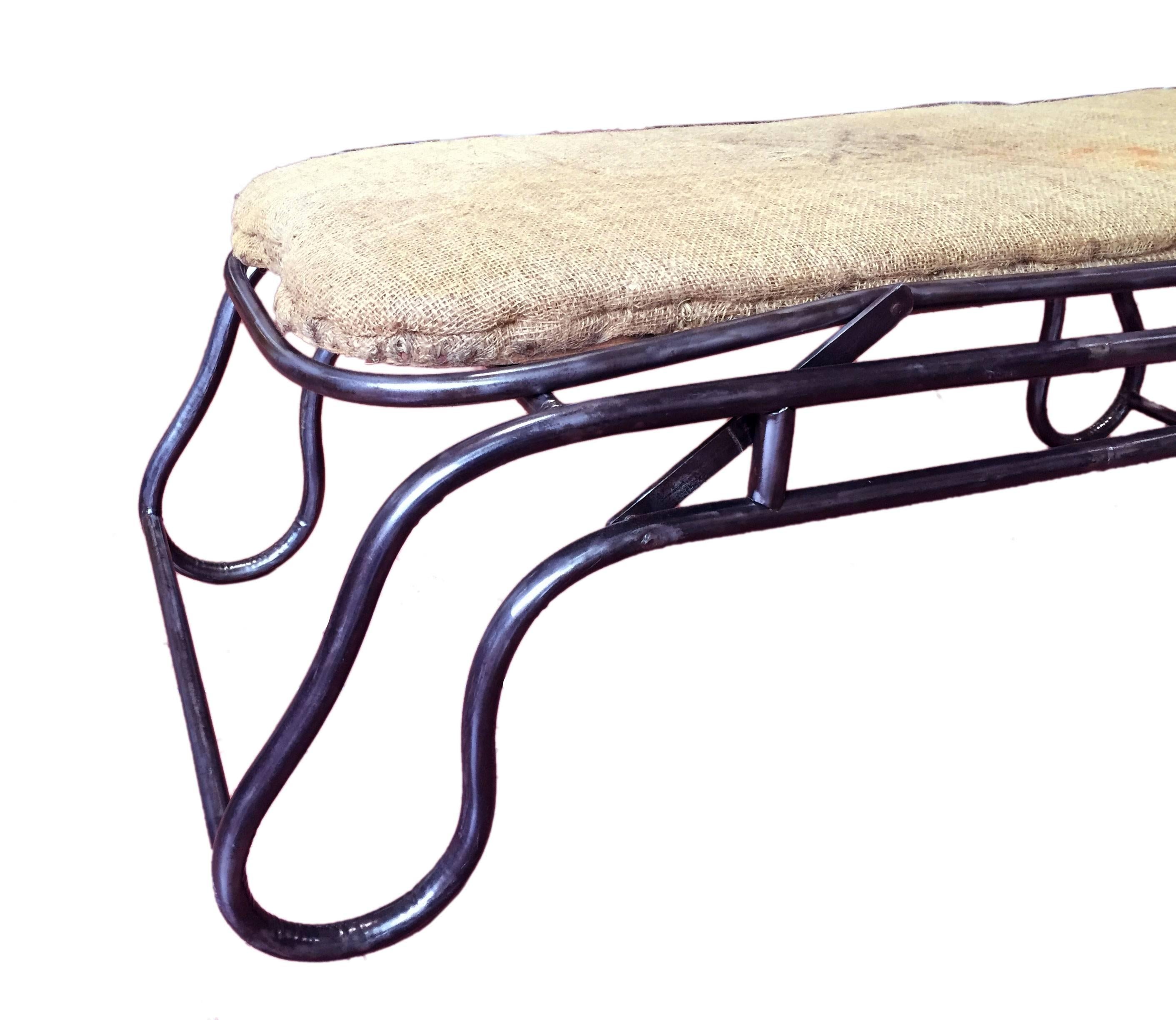 Splendid example of design for a chaise longue. The structure is made out of iron preciously curved in a superb movement. By lifting the feet side of the chaise, the entire bed rise. Original canvas, France, circa 1900.