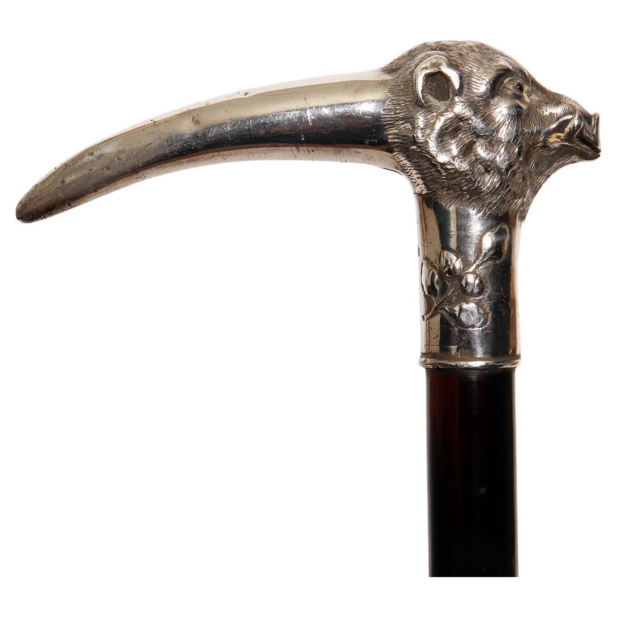 Walking stick: silver handle, depicting a boar’s head with acorns and leaves. glass paste eyes. Ebony wood shaft. Metal ferrule. Germany circa 1900.

