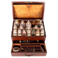 A trunk style travel apotecary cabinet in mahogany wood and brass, England 1790.