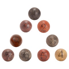 Nine spheres: weighting only twice and try to find the heaviest one, France 1900