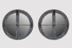 A pair of large round mirrored windows with wooden frames France, 18th century.