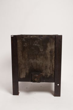 An iron industrial oil container, reused as flower box, United States early 1900