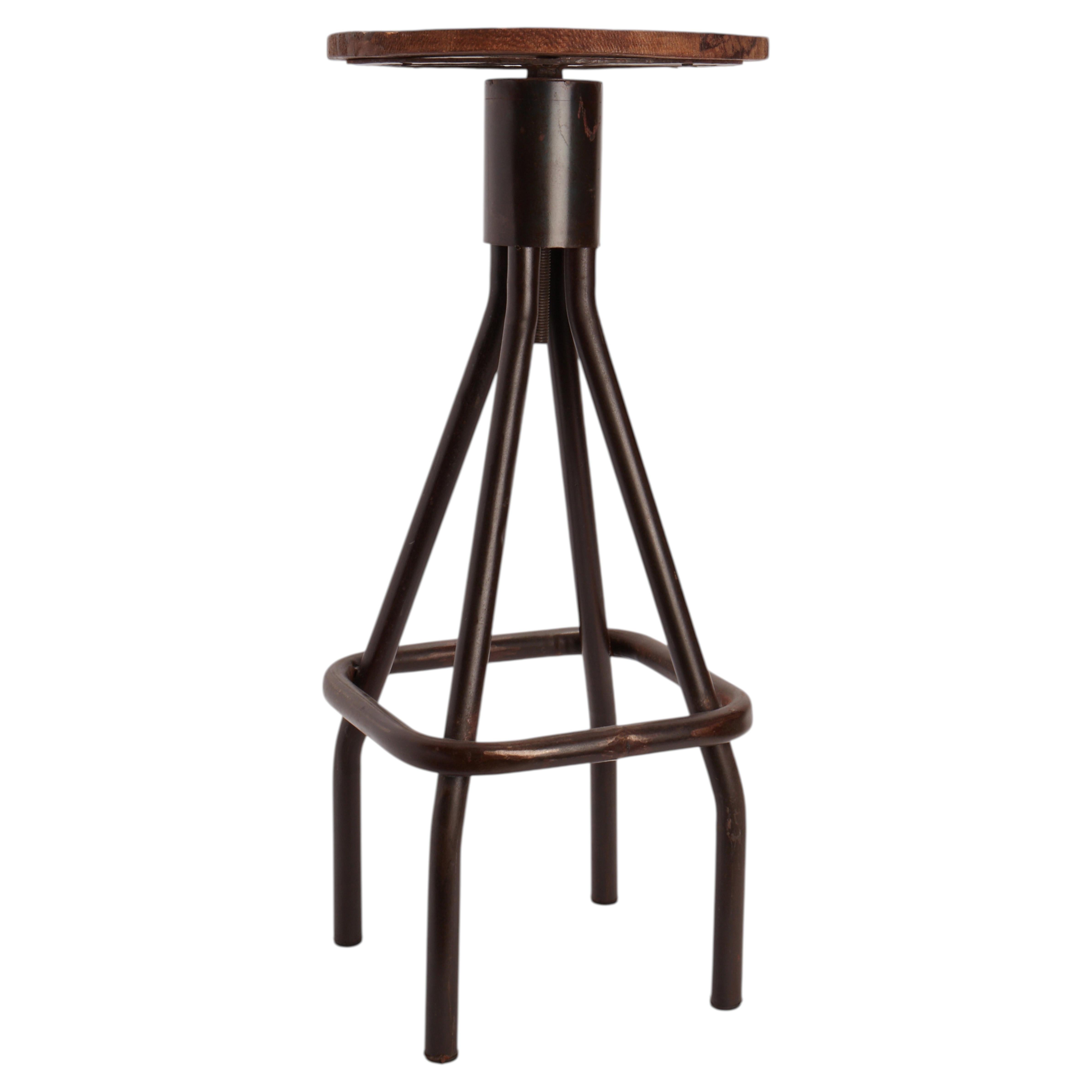 Industrial wood and iron adjustable bar stool, United States circa 1940. For Sale