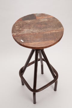 Industrial wood and iron adjustable bar stool, United States circa 1940.