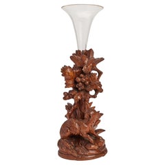 A black forrest wooden sculpture fox and bird with a glass vase, Germany 1880.