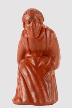 An amusing terracotta snuff box in the form of a squatting woman. France 1810.
